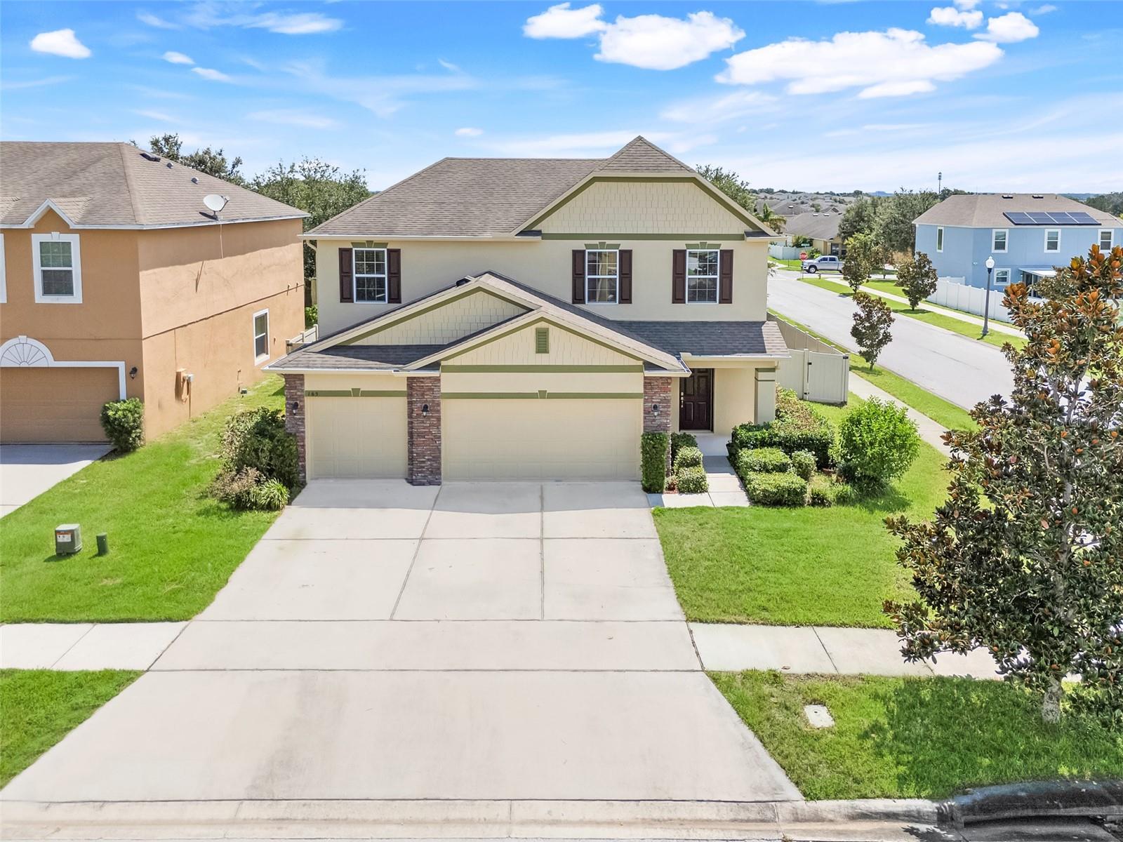 LARGE HOME ON A CORNER LOT. Welcome to a home that blends comfort, style, and plenty of space to enjoy life both inside and out. From the moment you arrive, the stone-accented front elevation and inviting curb appeal set the tone. Inside, you’ll find a large great room that flows into the sunroom and lanai—perfect for morning coffee, family time, or entertaining friends. The eat-in kitchen shines with 42" cabinets, solid surface countertops, and crown molding, while upgrades like extensive ceramic tile flooring and plush carpet make the home feel warm and welcoming. Upstairs, the bedrooms offer privacy and space, and the garden tub is ready for relaxing evenings. With the 3 car garage, you have enough for your vehicles and storage. Outside, the corner lot with a big fenced backyard gives you all the room you need to play, garden, or let the pets run free. And just steps away, you’ll love having a large park nearby—perfect for walks, picnics, and enjoying Florida’s sunshine. This is a home that checks all the boxes—inside, outside, and in the neighborhood too. Close to schools and shopping.
