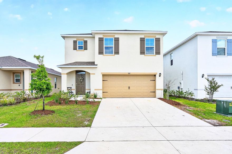 Seller may consider buyer concessions if made in an offer ~ BUILT IN 2025 and offering the largest floor plan available in the desirable Magnolia Pointe community of Umatilla, this spacious 5-bedroom, 3-bath home is MOVE-IN READY now – no need to wait for new construction! Designed for modern living with room to grow, this light and bright two-story home combines open living spaces, stylish finishes, and a location that keeps you close to everyday conveniences while still being outside the hustle and bustle of Orlando. Inside, UPGRADED TILE FLOORING flows throughout the main living areas, CUSTOM ACCENTS add character, and the OPEN CONCEPT layout creates the perfect space for gathering and entertaining. The kitchen is truly the heart of the home featuring desirable shaker-style cabinetry, sleek countertops, on trend hardware and fixtures, STAINLESS STEEL APPLIANCES, a large ISLAND with bar seating, and ample storage. The living and dining areas are filled with natural light with sliding glass doors that open to the patio and PRIVACY FENCED BACKYARD for seamless indoor/outdoor living. The MAIN FLOOR BEDROOM and full bath offer flexibility for guests, multi-generational living, or a home office setup. Upstairs, a cozy LOFT at the top of the stairs creates additional flexible space, while the generous PRIMARY SUITE is privately positioned at the front of the home complete with an oversized WALK-IN CLOSET featuring a window for natural light and a well-appointed en-suite bath. Three additional bedrooms are at the back of the home with access to a third full bath, and the convenient SECOND FLOOR LAUNDRY ROOM makes everyday living easy. Residents of Magnolia Pointe enjoy a LOW HOA along with community amenities that include a POOL, sports field, PLAYGROUND, and DOG PARK. Conveniently located with easy access to 450A and S Central Ave, you are just minutes from shopping, dining, outdoor recreation, and the beautiful Eustis Chain of Lakes. If you have been searching for a spacious newer home with modern finishes, community amenities, and room for everyone – Amberwood Way checks all the boxes. Call today to schedule a tour!