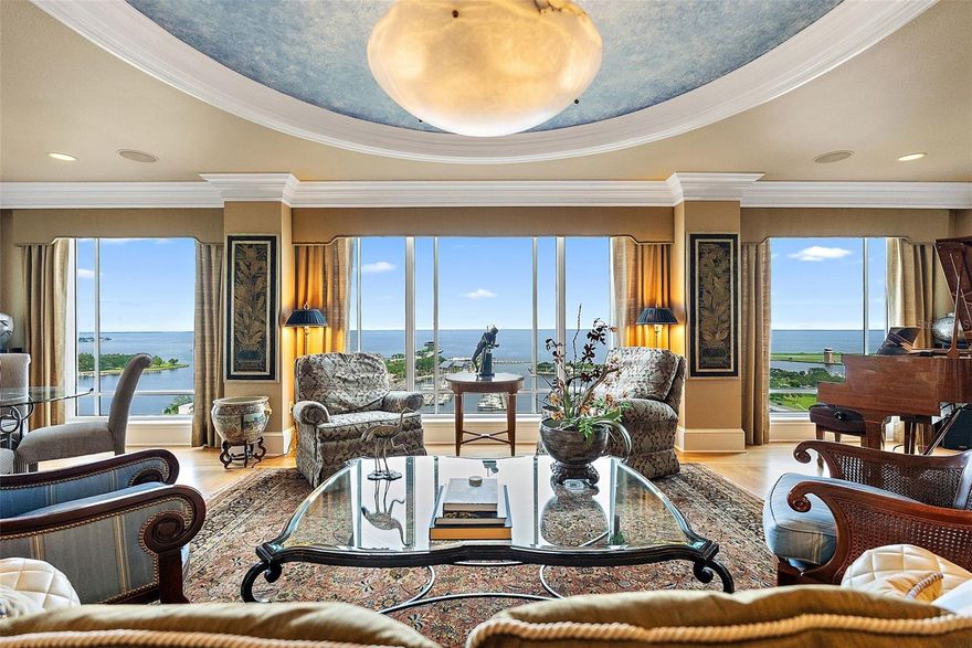 Enjoy some of the best views St. Petersburg has to offer from this elegant residence in one of the city’s most desirable towers. The “02” line is the most sought-after in The Florencia, facing directly toward the water with wide-open, unobstructed views of Tampa Bay and the downtown waterfront. From the 19th floor, the vantage point is exceptional, with the expanse of the bay stretching out by day and the St. Petersburg Pier beautifully illuminated at night.

A wall of windows spans the main living area, kitchen, and owner’s suite, fostering constant enjoyment of the stunning views. Two private balconies frame the waterfront and provide perfect spots to take in the bayside breezes with morning coffee as the sun rises out of the bay or evening beverages as the Pier comes alive with light. Gorgeous walnut floors with a stunning hand-cut inlay set the tone as you enter the grand foyer, leading to open living and dining spaces highlighted by three oval tray ceilings in the foyer, dining room, and living room for architectural elegance. The kitchen offers abundant storage, granite counters, and a suite of Viking appliances, including two built-in microwaves—perfect for warming leftovers from the endless array of celebrated restaurants just steps away. The dining room easily accommodates twelve for formal gatherings, and the home is richly detailed with extensive built-ins, fine woodwork, and crown moldings that carry throughout. The master suite is beyond luxurious, with a generous bedroom that provides room for both a large bedroom set and a sitting area, incredible water views, and direct access to its own balcony. Of the three bedrooms, one is currently configured as a media room and another as an office, which could easily be converted back to a bedroom. The home is full of thoughtful details to enhance entertaining and day-to-day living, including a living room wet bar, a full electronics suite, and more.

Since its construction in 2000, The Florencia has been one of the most desirable buildings in the Tampa Bay area. Built by renowned local developer JMC Communities and supported by a famously well-run association, it offers 24-hour concierge service along with amenities that include a pool, spa, fitness center, and elegant social rooms. Its prime position on Beach Drive places the best of downtown St. Petersburg at your doorstep, from waterfront parks and galleries to fine dining and the St. Petersburg Yacht Club. Two garage parking spaces and a private storage unit are included.