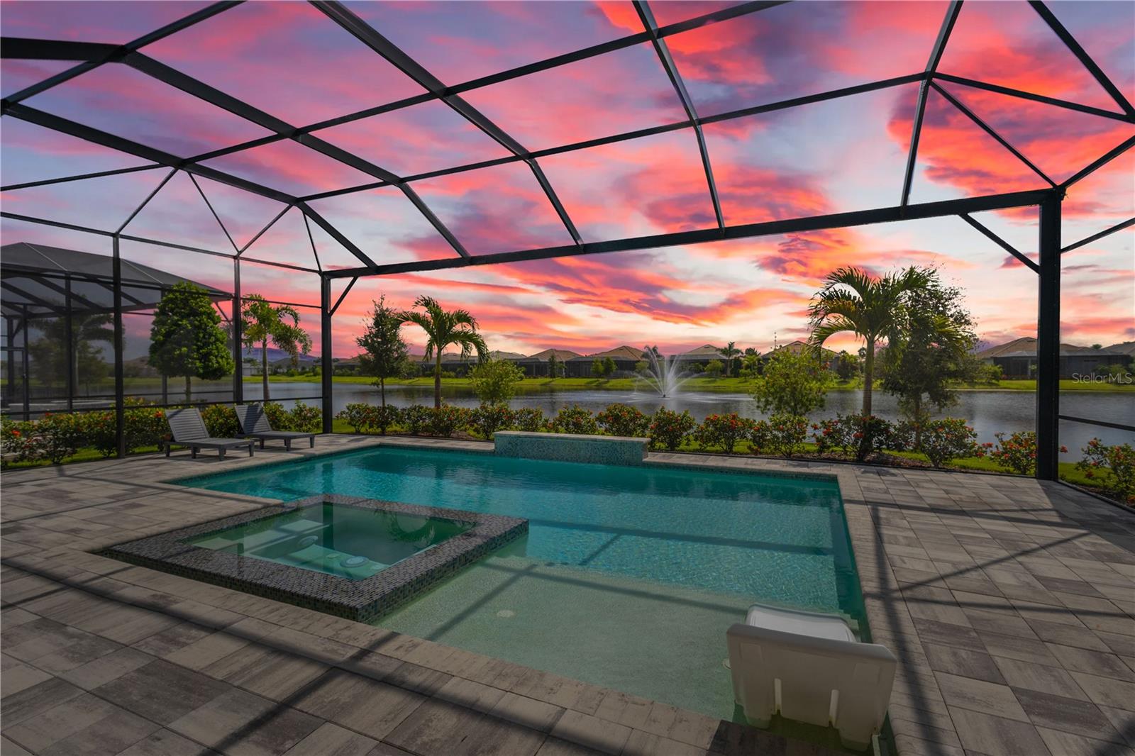 Nestled behind the gates of The Lake Club, this barely-lived-in 2023 built lakefront home is the pinnacle of luxury Florida living. Featuring three bedrooms, three-and-a-half bathrooms and a dedicated home office, this contemporary home was designed with function and beauty in mind. Over 2,600 square feet feel even more expansive with soaring ceilings, crown molding and architectural tray ceilings accentuating nearly every room. The open living space is anchored by the Chef’s kitchen including; Custom Shaker-style cabinetry, oversized quartz island with bar seating for three and built-in, top-of-the-line stainless steel appliances. Seamless indoor-outdoor living is achieved with pocketing, impact-rated sliding doors connecting to an additional 600 square feet of covered lanai and the extended pool area beyond. Encapsulating true Florida living, a custom pool features a sunken, 360-degree edge spa, sun shelf and waterfall feature. After a day in the sun, retreat to an owner’s suite designed for relaxation with freestanding tub, separate walk-in shower, dual, split vanities and two customized walk-in closets. A spacious three-car garage with additional custom storage and epoxy floors provides all the room you need for your toys. The Lake Club redefines luxury living in Lakewood Ranch, presenting residents a 22,000 square foot Grande Clubhouse with a full-service restaurant and bar, two resort-style pools, fully equipped fitness center, spa services and concierge amenities. Residents also have access to several tennis and pickle ball courts, basketball court, two dog parks and social events curated by a dedicated Lifestyle Director. Within America’s top-rated multigenerational community, you’re just minutes from upscale dining and shopping at Waterside Place and University Town Center, world-renowned golf and convenient to Downtown Sarasota, Gulf Beaches and cultural venues like the Van Wezel Performing Arts Hall.