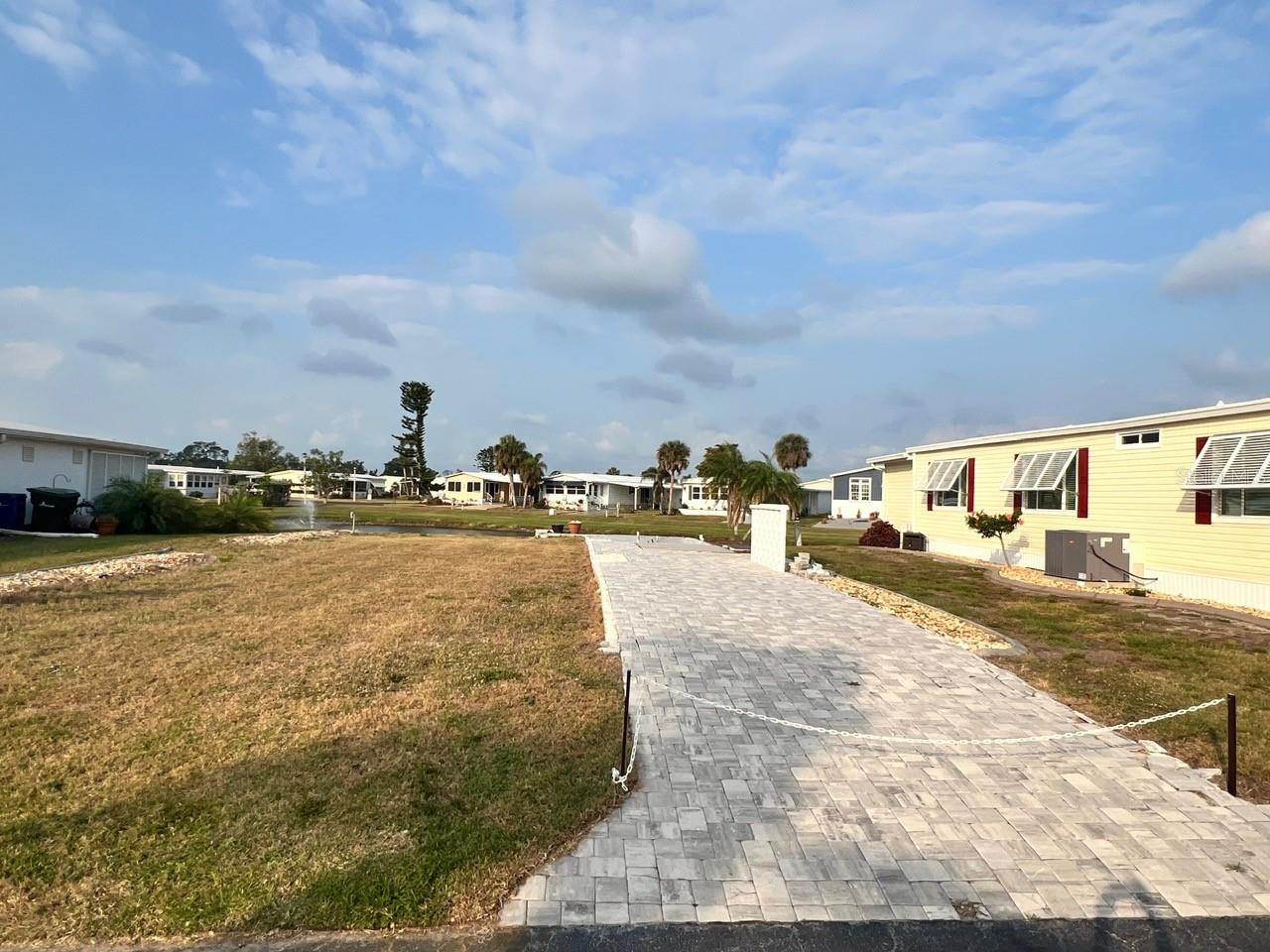 Have Your Chosen New Home built in this desirable 55+ Community! Vacant Ready to build lot!
No code worries when you have your brand new home placed on this beautiful waterfront lot. NO Worries, Water, Sewer, and Electric already in place. Alameda Isles 55+ Community has so much to offer. With low HOA fees and all the wonderful amenities. Picture yourself in your Florida Home, in your lanai sipping your morning coffee, Sitting by the pool relaxing in the Sunshine or hanging out in the Hot tub. When you want to socialize join in with the many events taking place in the community center and around the park. Like Boating, Alameda Isle has boats slips on first come first serve basis for an additional fee. Ride the canal to the intercostal and even out to the Gulf! What are you waiting for? Sunny Florida is wait for you to enjoy!