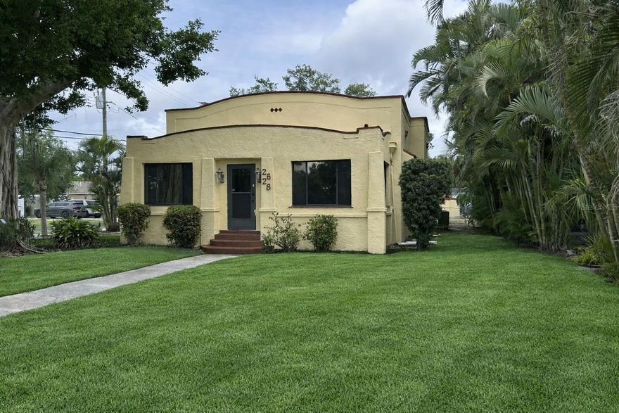 One or more photo(s) has been virtually staged. This meticulously maintained 1920 Spanish-inspired residence sits on an oversized corner lot beautifully framed by a stunning banyan tree that anchors the front yard. The enclosed front porch spans the width of the home and offers a bright, window-lined retreat with multiple seating areas—perfect for morning coffee or quiet afternoons.

Inside, the home highlights the craftsmanship of its era with original hardwood floors, tall ceilings, 10-inch baseboards, and detailed crown molding. Solid wood doors, substantial trim work, brass hardware, and glass doorknobs further enhance its authentic character. The living room flows into a generous dining area and a freshly painted kitchen featuring ample cabinetry, stainless steel appliances, a farmhouse sink, a propane gas range, and a large window overlooking the property.

The primary bedroom includes a total of three closets, providing plenty of room and storage. Two additional bedrooms are located just down the hallway, which also leads to the covered and screened porch. Adjacent to this area, a spacious deck  leads to the private in-law suite, complete with its own entrance, fully equipped kitchen, family room, fourth bedroom with a walk-in closet, and an updated full bathroom. This suite can remain independent or be reconnected to the main home—ideal for extended family, guests, or income-producing rental potential.

The backyard offers a tranquil setting for birdwatching and enjoying the harvest from mature fruit trees, including mango. A large storage shed adds convenience for tools, equipment, and seasonal items.

The extensive list of major improvements provides exceptional peace of mind:
New Roof (2024), New Plumbing/Re-pipe (2025), Newer AC and Water Heater (2019), New Electrical Panel (2020) with additional electrical updates in 2024, a 2024 mold inspection with no issues found, satisfactory 4-Point and Wind Mitigation inspections (2024), and full termite tenting in June 2024 with a transferable one-year warranty.

Located just one street from the bay and minutes from shopping, groceries, and Downtown Bradenton, the home is also only 2.4 miles from Emerson Point Preserve, offering waterfront trails, kayak and canoe launches, jet ski access, and scenic picnic areas. Boaters will appreciate being just one mile from the Bradenton Yacht Club.

This property delivers a rare combination of historic architecture, flexible living options, and significant modern upgrades in a highly desirable coastal setting. Just unpack your bags—this turn-key home is ready for you.