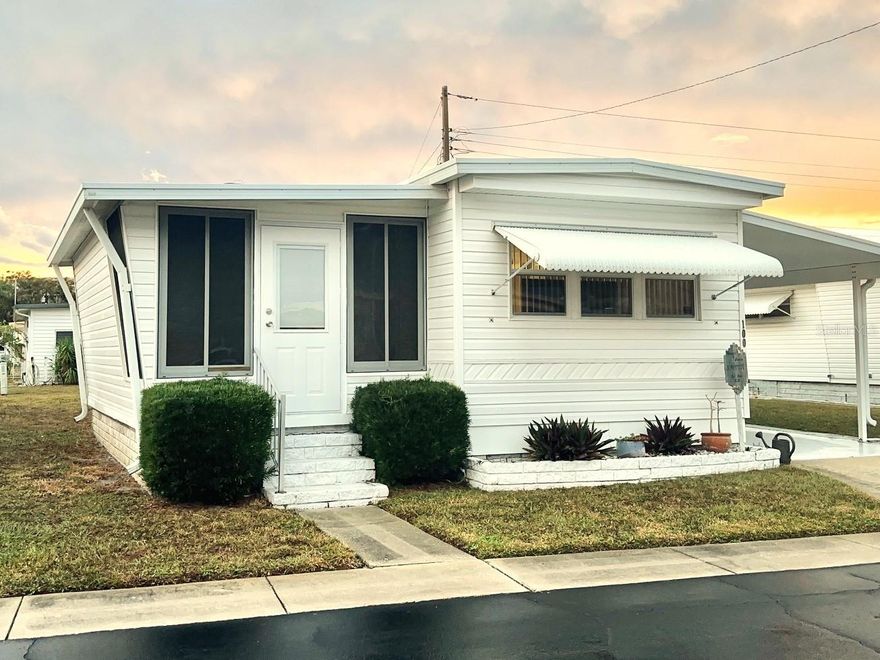 Hurry to see this beautiful decorator Florida Resort Home, with all the upgrades! Spacious 2 bedrooms, 1 bath, with additional 10x20  bump out living area to enjoy! Feels like a doublewide! All light & bright open great room, with newly added storm proof windows, and beautiful view of pool & fun clubhouse! All decorator laminate floors, with 3/4 inch subfloors, updated vapor barrier under home, Central Air/Heat Unit ‘20, 40 gal. Water Heater, and so much more! Insulated Roof Over & Vinyl Siding! All newer furnishings included!! This inviting & attractive home is ready to move in! Located in the popular 55+, 5 Star Resident Owned, Active Community of Colonial Village! Right next to shopping, minutes to golf courses, beaches, Pinellas bike trail, airports, and VA Medical! Do not miss this gorgeous home! Cash only! Asking $109,900, includes the Share! Low $210. Mo. Fee, covers your water, sewer, garbage, yard, and all the wonderful amenities!