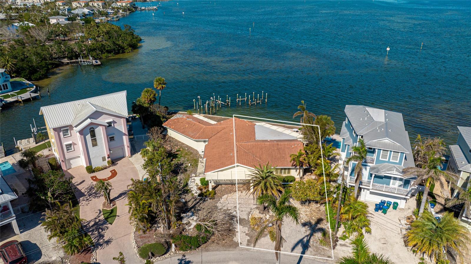 RARE LOT #35 WITH WATER FRONT WITH AMAZING VIEWS/ access. WEEKLY RENTAL ZONING & BUILDABLE DOCK POTENTIAL! Investor and builder dream! This unique lot property at 236 S Harbor Drive in Holmes Beach offers sweeping views of Anna Maria Sound and the Sunshine Skyway Bridge, and sits just a short walk to the beach. Zoned for weekly rentals, this is a prime opportunity for a custom-built vacation rental, personal island retreat, or investment property. New construction options start as low as $375K for a 2-bedroom, 1-bath design, with customizable plans available for a luxury 4 bedroom, 3.5+ bath two-story estate estimated around $1.016M. Builder plans and cost estimates available upon request. The current home was damaged by storms, Home sites in the middle of both lots, This property also allows for a buildable private dock suitable for a nice size boat—perfect for boating, fishing, or increasing rental value. Weekly Rental Zone. Water Views of Anna Maria Sound & Skyway Bridge. Buildable Dock for Boat. Walk to the Beach, Builder Plans Available – Starting at $375K Don’t miss this rare development opportunity on Anna Maria Island with location, views, and incredible income potential! Buyers responsible to verify all information. Actual lot SQF will be determined once the split occurs PER SELLER. BOTH LOTS ARE AVAIL SEE MLS A4655001