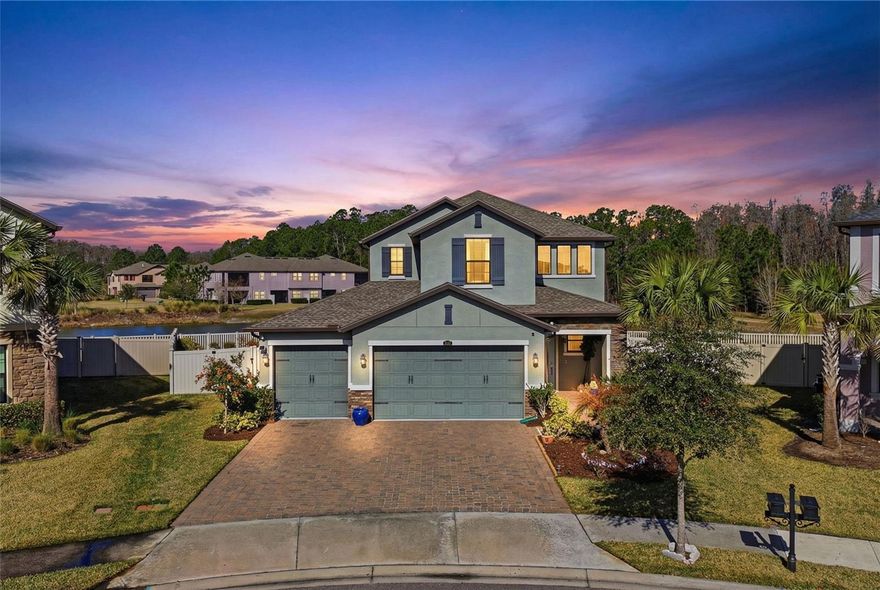 One or more photo(s) has been virtually staged. Welcome to this exceptional home nestled in a gated community, perfectly positioned on a quiet cul-de-sac and situated on an oversized lot with serene private pond views. This spacious residence offers 4 bedrooms, 3 full bathrooms, and a 3-car garage, designed with both comfort and functionality in mind. The open floor plan creates a seamless flow throughout the main living areas, where the bright and airy kitchen overlooks the expansive living and dining room combination. The focal point is the stunning pond views and HUGE backyard! The contemporary kitchen offers 42 inch cabinets, stone counters, stainless steel appliances and double ovens perfect for entertaining. The entry foyer area offers high ceilings and abundant light throughout the home. A private guest bedroom is located on the first floor and a full bathroom is adjacent to the room. Upstairs, the spacious owner’s suite showcases tranquil pond views and a beautiful contemporary bathroom featuring stone countertops, double vanities, a large walk-in shower, and a connected walk-in closet. Two additional bedrooms are located on the second floor and share a convenient Jack-and-Jill bathroom. One of the bedrooms offers a custom-designed closet and currently functions as a stylish home office, providing flexibility to suit your needs.  If you’re looking for privacy, space, and stunning views, this home delivers with its oversized lot and generous indoor and outdoor living areas. The paver driveway and walkway enhance the home’s curb appeal, all set on a quiet street. Located in the highly desirable community of Estancia, this home offers a prime central location close to restaurants, shopping centers, medical facilities, malls, movie theaters, top-rated schools, and convenient highway access. Enjoy being approximately 30 minutes from Downtown Tampa, about 1.5 hours from Orlando’s Disney parks, and roughly one hour from some of Florida’s beautiful Gulf Coast beaches.