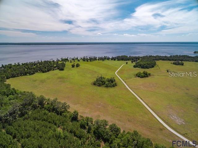 Welcome to Andalusia Bay, a one-of-a-kind waterfront equestrian community where wide-open spaces and endless possibilities await. This incredible 10.3-acre homesite (Lot 25) offers the perfect canvas to create your dream estate, whether that means a private homestead, a working ranch, or a stunning custom home surrounded by nature. Set along the scenic banks of Crescent Lake, Andalusia Bay combines the charm of rural living with the luxury of space and privacy. Imagine waking up to peaceful sunrises over the water, enjoying afternoons spent boating, fishing, or horseback riding, and ending each day with breathtaking views of Florida’s natural beauty—all from your own backyard.
With generously sized parcels ranging from 5–10 acres, this exclusive community was designed for those who value both land and lifestyle. Here, you’ll have room to spread out, build, and truly make your property your own. Whether you envision a modern farmhouse, a classic equestrian estate, or a serene waterfront retreat, this lot provides the rare opportunity to bring that vision to life. Andalusia Bay is not just a neighborhood—it’s a destination for those seeking space, freedom, and connection to the outdoors, while still being within reach of modern conveniences. Opportunities like this are rare, and Lot 25 is ready for the next owner to turn it into something extraordinary. Don’t miss your chance to claim your piece of Florida paradise.