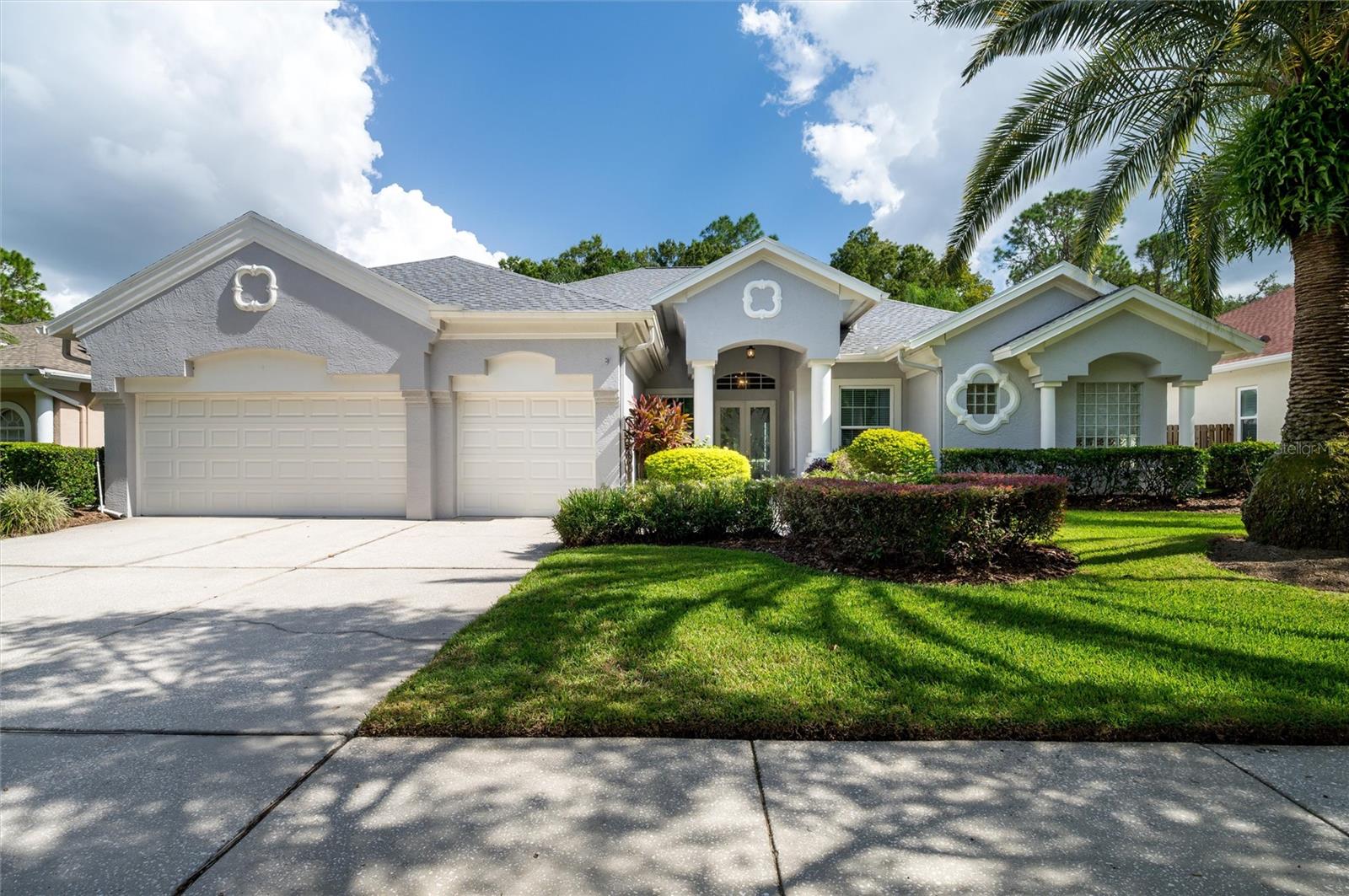 Ideally located in the gated Hunters Green Golf Course community with 24-hour security, this spectacular home offers a rare blend of luxury, privacy, and thoughtful design - all just minutes from grocery stores, retail shops, and a variety of wonderful restaurants. Meticulously maintained, it features ultra-high ceilings and rich wood floors throughout the bedrooms, office, living, and dining rooms, creating a warm and elegant atmosphere. The primary suite has two spacious walk-in closets along with direct access to a large lanai, which is also accessible via triple pocket sliding glass doors from the family room and sliders from the living room. The lanai is perfect for entertaining, offering generous space for seating and dining, an outdoor kitchen, and a natural stone deck that extends to a private saltwater pool and gas-heated hot tub. Positioned on the golf course yet uniquely secluded with a serene forest view, this home offers both distinction and tranquility.
Priced below current appraisal, recent upgrades include a new roof (September 2025) with high-quality GAF shingles and a fully transferable, extended warranty, as well as a Wind Mitigation Certificate for potential homeowner’s insurance discounts. In 2022, double-pane, Low-E windows were also added throughout the home for enhanced energy efficiency and year-round comfort, and many more. Two Quorum ceiling fans, crown molding and other high-end finishes enhance the ambiance, while the nicely landscaped exterior and 3-car garage with plenty of built-in storage racks complete this exceptional offering.