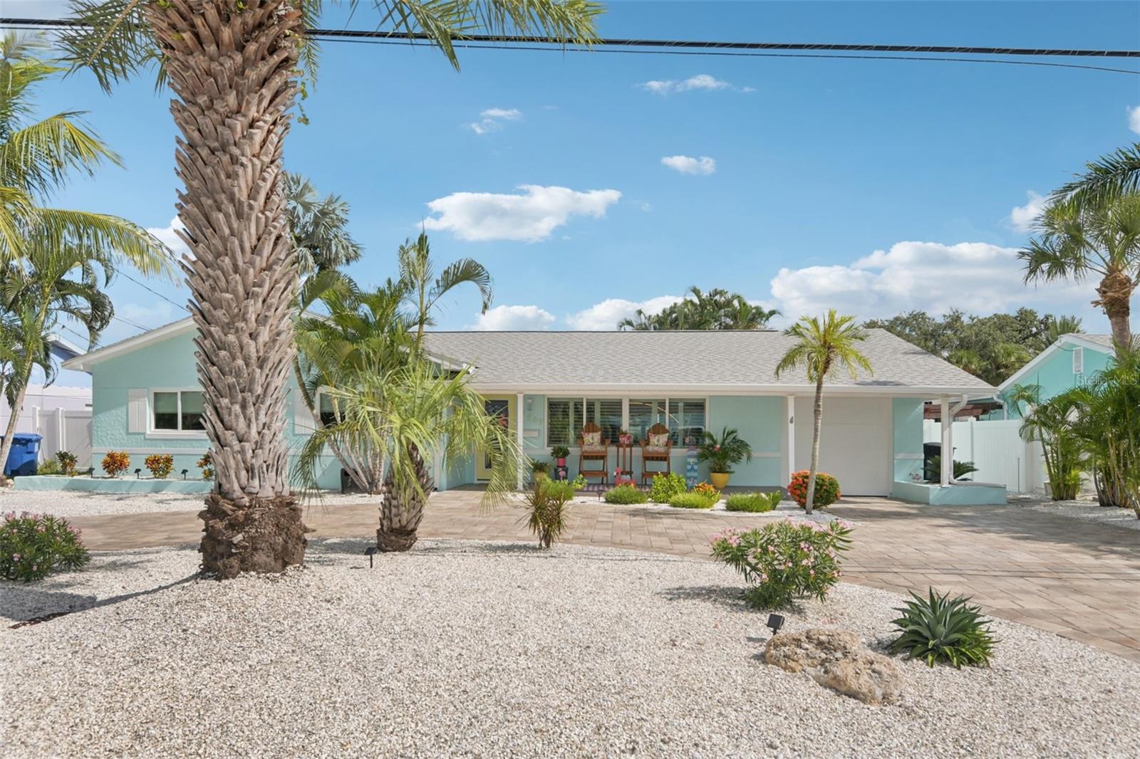 Beautifully renovated 3BR/2BA pool home in the coveted Causeway Isles— available and move-in ready! This coastal retreat has undergone a complete transformation with recent improvements, making it a truly turn-key property. Major updates include brand-new hurricane impact windows, doors, and a 3-panel slider, a new roof with hurricane straps, soffits, and enhanced drainage. The exterior has just been freshly painted, and the paver driveway, insulated garage door, composite front porch, and back patio add lasting curb appeal. Step inside to a light-filled open layout with luxury vinyl plank flooring, new drywall, paint, baseboards, hardware, and modern fixtures throughout. The kitchen showcases granite countertops, new cabinets, and Samsung stainless steel appliances, while the bathrooms feature stylish new vanities, sinks, faucets, and contemporary finishes. Even the garage boasts epoxy waterproof flooring for durability. The backyard is a private oasis designed for entertaining—complete with a resurfaced saltwater pool featuring a heater and waterfall, an outdoor TV on the pool deck, lush palm trees framed by a vinyl privacy fence, and a fire pit for evening gatherings. The landscaping has been thoughtfully zero-scaped with shells for a low-maintenance, tropical vibe. Additional peace-of-mind upgrades include a new pool motor and filter, a new hot water heater, and reclaimed water piping for efficiency. Perfectly located just 3 miles from the shops, dining, and nightlife of John’s Pass, and only minutes from the beaches and downtown St. Pete, this property blends style, comfort, and durability in one of the area’s most desirable waterfront communities. Homes this updated and meticulously cared for in Causeway Isles rarely last—don’t miss your chance to own a true Florida oasis!