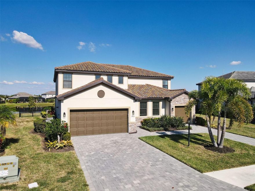 Welcome to luxury living in the gated, amenity-rich community of Lorraine Lakes in Lakewood Ranch. This expansive 6-bedroom, 4.5-bath, 3,908 sq. ft. home sits on a generous 0.26-acre homesite and offers the perfect blend of elegance, comfort, and versatility.
Designed for multi-generational living, this property features a private in-law suite complete with its own kitchenette, full bath, spacious bedroom, living area, and a dedicated single-car garage—a rare find. The main home offers an additional two-car garage, creating ample space for vehicles, storage, and lifestyle needs. Inside, you’ll find multiple upgrades throughout, highlighted by bright open living spaces, modern finishes, and flexible room configurations to suit a variety of living arrangements. Step outside to your own private oasis. The extended lanai showcases a large saltwater pool, spa, and sun shelf, all overlooking a tranquil lake view that provides the perfect backdrop for relaxation or entertaining. Residents of Lorraine Lakes enjoy access to an unparalleled suite of amenities, including multiple resort-style pools, tennis and pickleball courts, basketball, a state-of-the-art fitness center, dog parks, and miles of walking trails—all within one of the nation’s top-selling master-planned communities. This exceptional home offers space, flexibility, and resort-style living—right in the heart of Lakewood Ranch. Don’t miss this rare opportunity!