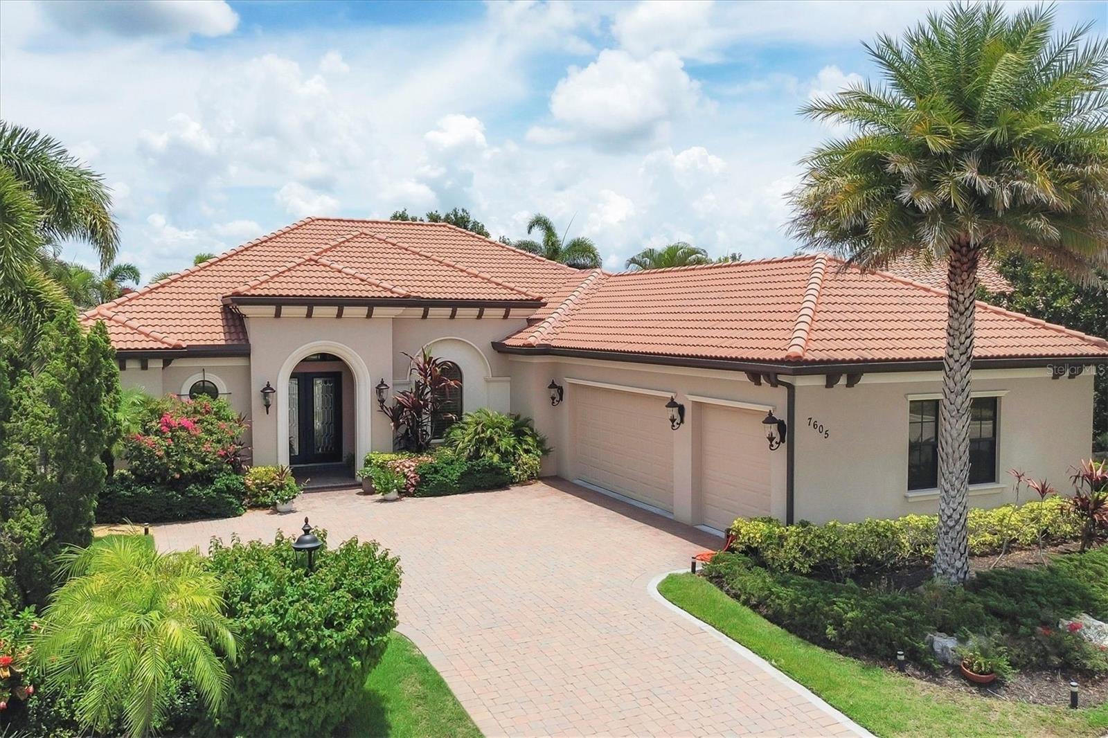 Welcome to your dream home—an elegant three-bedroom, three-bathroom masterpiece in the highly coveted Country Club East neighborhood. This stunning residence harmoniously blends luxury and comfort, offering a spacious open layout and breathtaking views of the serene lake. As you step through the grand double doors, you’ll be immediately captivated by the expansive great room, drenched in natural light. The gourmet kitchen is a culinary enthusiast's paradise, featuring elegant granite countertops, double islands, top-of-the-line stainless steel appliances, and under-cabinet lighting that elevates your cooking experience. The inviting den, complete with French doors, provides a quiet sanctuary for relaxation or focused work. Retreat to the primary suite, a true oasis of tranquility that boasts expansive lake views. This serene space features a tray ceiling, crown molding, a spacious double walk-in closet, and a luxurious ensuite bath with double sinks, a soaking tub, and an exquisite walk-in shower. Two additional generously sized bedrooms and bathrooms ensure your guests enjoy privacy and comfort on the opposite side of the home. Step through the pocketing sliders to your large lanai effortlessly merging the indoor and outdoor spaces. This is your outdoor oasis and the perfect place to entertain guests with the well-appointed outdoor kitchen, complete with a grill, sink, and granite countertops, this space is designed for memorable gatherings. Additional amenities, such as remote blinds in the living room, Kevlar hurricane shutters, and a Pelican water system, enhance the ease and comfort of everyday living. Life in this remarkable home provides not just a dwelling but a lifestyle. As a resident of Country Club East, you’ll enjoy exclusive access to The Retreat, an upscale amenity center featuring a resort-style pool, a state-of-the-art fitness center, and a billiards room. The Residents Club also offers another pool, a spa, and a volleyball court, ensuring leisure and recreation are just steps away. Plus, the nearby Lakewood Ranch Golf & Country Club features 72 holes of golf, 20 tennis courts, 20 pickleball courts, multiple pools, a grand clubhouse, and The Lodge bar and restaurant—all available through a variety of membership options. Seize the opportunity to call this extraordinary home yours and enjoy life in Lakewood Ranch, America’s top-selling planned multigenerational community! Your ideal lifestyle awaits!