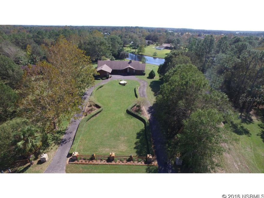 Country Comfort! Lakefront estate sits on nearly 4 acres. Bring your horses. There's a 1,200 sf. 4 stall barn. Super house perfect for a large family that enjoys festive gatherings. Circular driveway. Tiled foyer. Tiled eat-in kitchen has sealed granite counter tops & wood cabinets. Formal living room & dining room. Wow! Look at the family room with cathedral ceiling, built-in bookcase & stone fireplace. Plenty of space for pool table & more. Split bedroom floor plan. Large master bedroom & bathroom suite. 3 sets of sliding doors to large screened lanai. Octagon wood deck & lanai overlook lake. Inside laundry room. Hobby room/dark room in garage. Well water softener system. Grinder pump septic system with large raised drain field. Sprinkler system. Check documents & house for feature list.