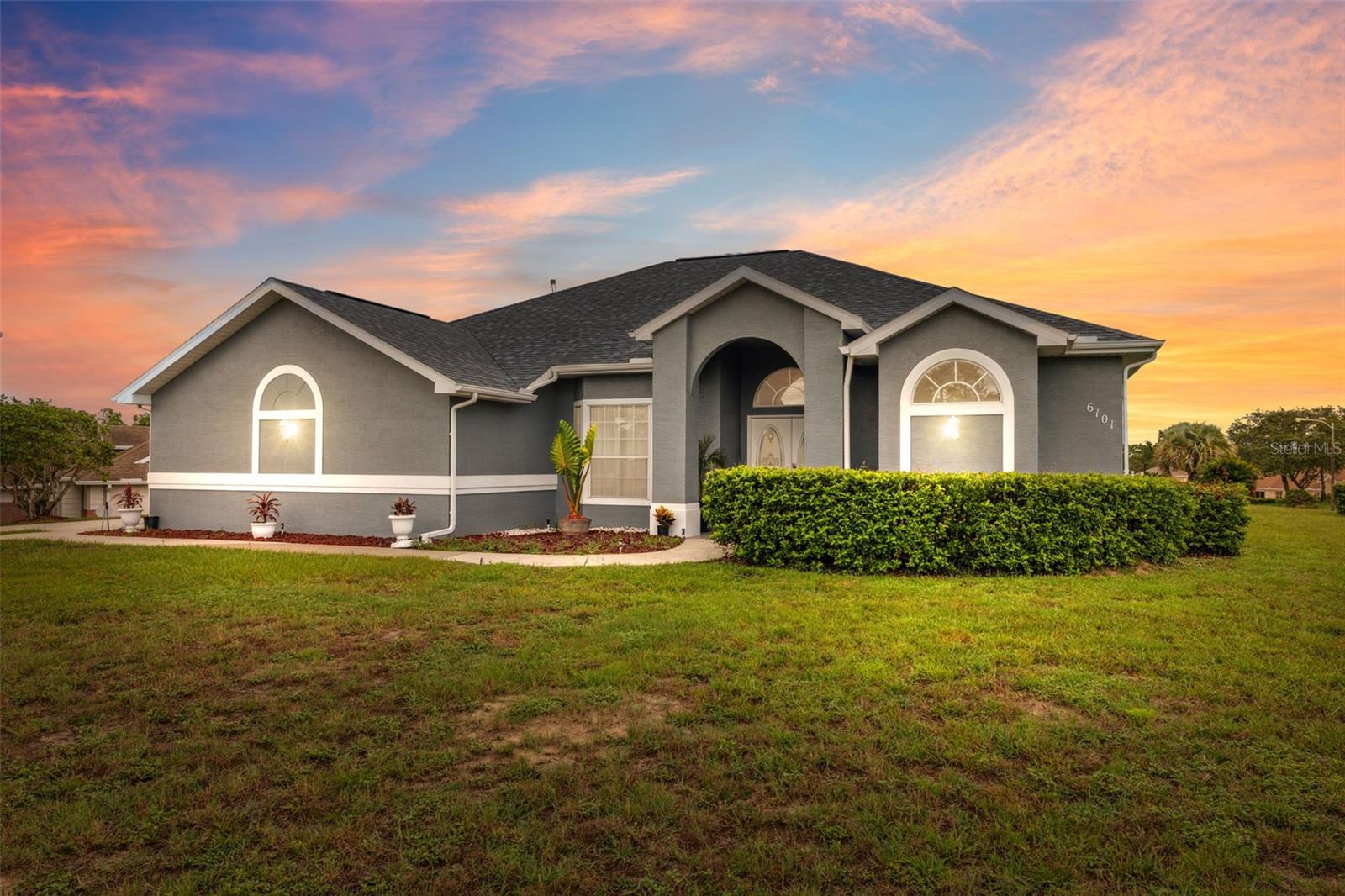 One or more photo(s) has been virtually staged. Set on an oversized corner lot in the desirable Oaks community, this beautifully updated pool home offers space, style, and natural light on over half an acre. A tall, wide, covered walkway leads to elegant double front doors and a tiled foyer that opens into a bright living room with wood laminate flooring and a full wall of sliding glass doors overlooking the pool. The formal dining area, just off the main living space, shares the same warm flooring and open feel. Throughout the home, tall ceilings create an open and airy feel. Toward the back, the kitchen and family room open into a welcoming space that features brand new appliances, crisp white quartz countertops, a light gray tile backsplash, an oversized sink, and striking dark blue cabinetry that adds contrast and character. The large breakfast bar is ideal for casual dining, and a sunny nook with a skylight and sliding doors offers a cheerful spot to enjoy morning light. The family room includes built-in shelving that adds both charm and practicality. The primary suite includes sliding glass doors to the lanai, two walk-in closets, and a spacious private bath with updated dark blue cabinets and white quartz countertops, dual sinks, a step-in shower, and a separate soaking tub. The two additional bedrooms also feature walk-in closets, and the second bathroom has been fully remodeled with matching dark blue cabinetry, white quartz counters, wood-look tile flooring in gray and white tones, and a walk-in shower lined with marble-look tile. A large laundry room with built-in cabinets and a utility sink adds convenience, while the side-entry two-car garage enhances curb appeal. The screened pool area includes pavers, a large covered lanai, and a spacious backyard—perfect for relaxing or entertaining. Recent updates include a 2021 roof, brand new HVAC and water heater in 2024, and a new pool pump in 2025. The home also features touchless entry for modern ease. Located just 6.5 miles from the Suncoast Parkway, it offers a quick and direct route for commuting to Tampa and surrounding areas. Nearby attractions include Weeki Wachee Springs State Park (6.8 miles) for kayaking and live mermaid shows, Hernando Beach (12 miles) with waterfront dining and Gulf access, and Pine Island Beach (14 miles), a peaceful local beach known for sunsets, swimming, and laid-back coastal charm.