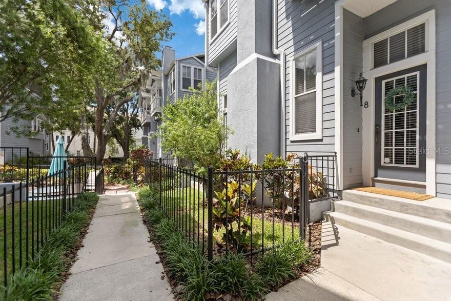 Experience refined urban living in the heart of Hyde Park in this elegant South Tampa townhome just steps from iconic Bayshore Boulevard and only a few blocks from the energy and charm of Hyde Park Village. Tucked within an intimate and beautifully maintained community surrounded by brick-paved courtyards, mature oak trees, lush landscaping, and a sparkling community pool, this residence offers the rare combination of sophisticated city living and a warm neighborhood atmosphere in one of Tampa’s most desirable locations.

Designed with a unique and sophisticated split-level floor plan, this light-filled corner residence showcases warm wood flooring throughout and an abundance of windows that create an airy, inviting atmosphere rarely found in townhome living. The thoughtfully designed main living area offers both formal living and dining spaces ideal for entertaining, while soaring ceilings and architectural details create warmth and character throughout. The stylish kitchen and family room combination features rich dark wood cabinetry, stainless steel appliances, breakfast bar seating, newer dishwasher, new disposal, and seamless access to a private rear balcony perfect for morning coffee or evening wine. French doors at the entrance overlook the pool and courtyard, blending indoor and outdoor living beautifully.

Upstairs, two generously sized bedrooms provide exceptional comfort and privacy. The luxurious primary suite features cozy window seating, French doors leading to a private balcony overlooking the pool, and a beautiful bathroom with dual sinks, floating vanity, glass-enclosed shower, and oversized walk-in closet with abundant storage. The spacious secondary bedroom offers its own ensuite bath and proportions comparable to many primary suites, creating an ideal layout for guests, roommates, or flexible living.

What truly sets this property apart is the unbeatable Hyde Park lifestyle. Enjoy easy access to Bayshore Boulevard’s scenic waterfront trail, Hyde Park Village’s upscale boutiques, fitness studios, coffee shops, and popular restaurants including Timpano, Forbici, Meat Market, On Swann, Ro Hyde Park, and Buddy Brew Coffee. Nearby SoHo offers vibrant nightlife, cocktail lounges, and entertainment, while Downtown Tampa, Water Street, Sparkman Wharf, the Tampa Riverwalk, Amalie Arena, and Raymond James Stadium are all just minutes away, making concerts, Lightning games, Buccaneers games, festivals, and waterfront events incredibly convenient.

Perfectly positioned near major roadways including Crosstown Expressway, I-275, and Selmon Expressway, this location also provides quick access to Tampa International Airport, Tampa General Hospital, MacDill Air Force Base, and the Westshore Business District. Whether enjoying a sunset stroll along Bayshore, biking through Hyde Park, grabbing coffee around the corner, or heading downtown for dinner and events, this residence delivers the perfect blend of luxury, walkability, convenience, and timeless South Tampa charm.