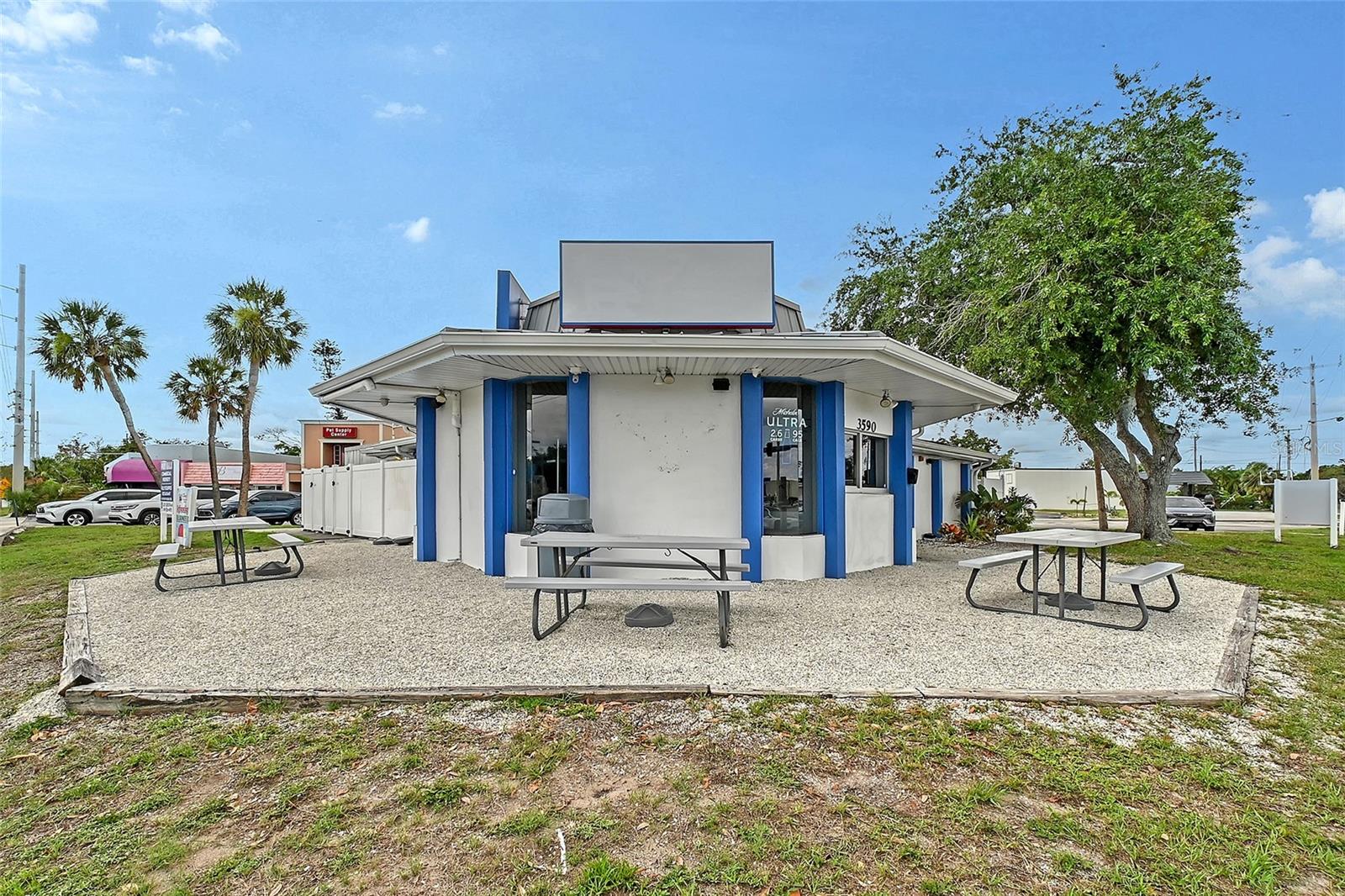 Wonderful opportunity to start a new venture or move your business to this business location. Owner has decided to retire after establishing this well-known sub/deli shop. Free standing building on busy corner lot. Owner is leaving this restaurant equipped with deli counter refrigerator, fryers, oven, grill, walk in refrigerator, ice cream chest, draft beer dispenser, etc. Building has central air and 2 Mitsubishi wall units for added cooling. Owner’s office includes copier, extra shelving for storage and holds equipment for ADT alarm and security cameras. New metal roof as well as new outside shell and electric screens to enclose the outside dining area which has 14 tables and chairs. Outside area has large commercial fans and 2 restrooms. The space can accommodate a variety of commercial uses, allowing for versatility in meeting the needs of prospective tenants or owners. This opportunity presents an exciting prospect for those seeking a property to establish or expand their commercial endeavors.