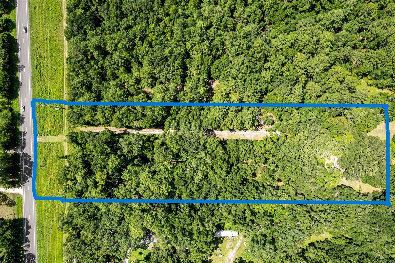 Welcome to your own slice of tranquility, located just off Parker Road and only a short drive from both Newberry and Gainesville. This beautiful piece of land offers the perfect balance of rural charm and accessibility. The property has cleared areas, a gorgeous homesite ready for your new build. It comes equipped with well, septic, and electricity already in place—an incredible head start for your future plans. Fully fenced with hog wire fencing, some areas do need repair from fallen trees. A small workshop adds storage, and there's also a mobile home on-site that can either remain or be removed before closing. While the home is livable, its insurability is uncertain and would need to be verified. SO you can live in the mobile home while you build your dream home. Even more exciting? UF recently purchased 225 acres nearby to develop into a future golf course, making this location even more desirable and full of potential. Quiet, accessible, and primed for growth, this is country living with a promising future. One of the most remarkable features of this parcel is its high and dry elevation, providing peace of mind and year-round usability. Whether you're coming home from a long day in Gainesville or simply enjoying a quiet afternoon outdoors, this land offers a true retreat—calm, quiet, and filled with potential. CASH, AS IS.
