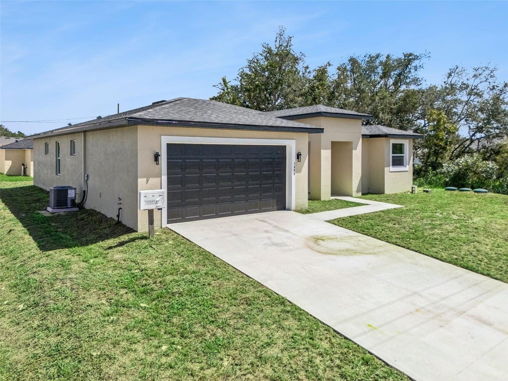 Photo of 1444 Sarasota Drive, Poinciana, FL 34759 (MLS # O6444635)