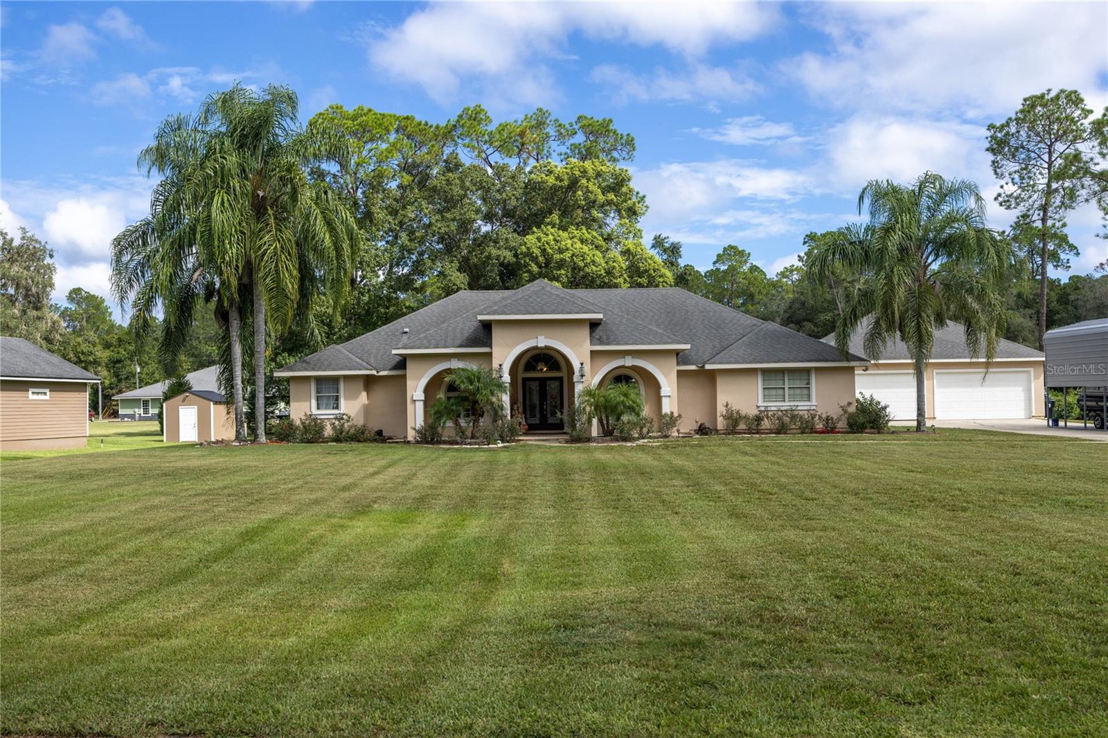 Pool home with Lake Geneva access! If you love the water, this house is for you. Conveniently located between Keystone Heights and Melrose, this open floor plan has everything you need.
The home features a large living area with a beautiful built-in entertainment center, the focal point of the room. This space opens to the dining nook and a large kitchen. The oversized eat-at bar wraps around the kitchen, which includes solid surface countertops, solid wood cabinets, and an island—perfect for entertaining.
Just off the living area, two French doors lead to a versatile room that can be used as an office or a formal dining area. Another set of French doors opens to your screened-in patio and saltwater pool.
The split floor plan offers a spacious master suite with two closets, a Jacuzzi tub with TV, and a roomy stand-up shower. The suite also provides direct access to the pool patio through a private entrance. On the opposite side of the home, two additional bedrooms share a bathroom with a stand-up shower.
The mudroom connects to a dedicated laundry room featuring cabinets, a folding counter, and an included set of front-load washer and dryer.
If you love the outdoors, you’ll enjoy relaxing in the screened-in swimming pool or heading down to the neighborhood’s private lake access to launch your kayaks or canoes.
There’s plenty of storage for vehicles and toys, with an oversized four-car garage that includes a dedicated side garage door for your ATV or lawnmower. A large carport provides covered storage for RVs, boats, or other large equipment.
Don’t miss this opportunity