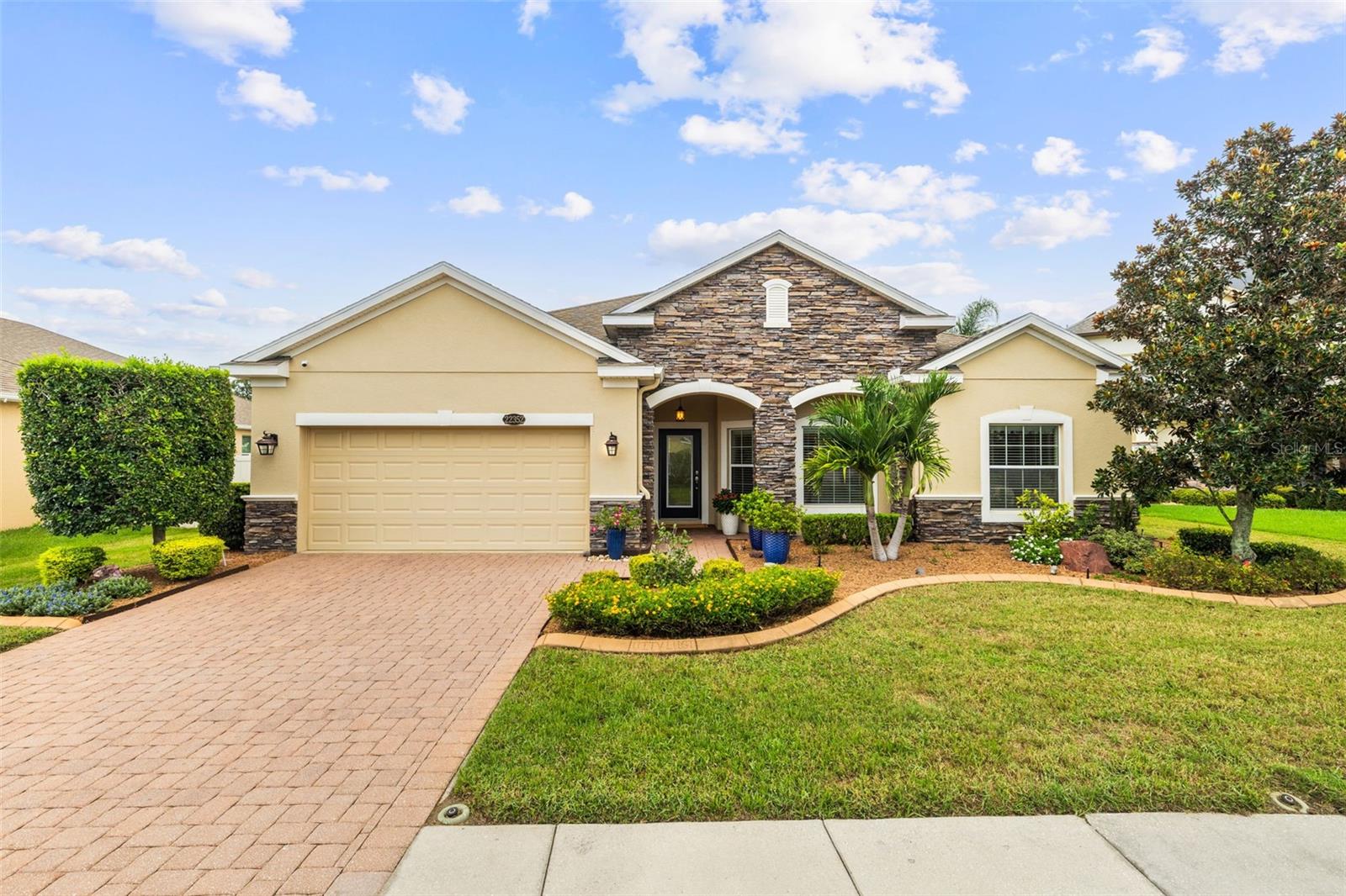 Elegant 3-Bedroom Home with Premium Upgrades in Alsace, a Gated Community in the heart of Land O Lakes.
Discover this beautifully upgraded 3-bedroom, 2.5-bath home located in a gated community of only 20 homes. Situated on a pond-view lot, this home combines privacy, charm, and modern luxury. This home is well cared for and meticulously maintained. Step inside to an open-concept layout with a bright and airy flex room, perfect for a home office, sitting area, or playroom—flooded with natural light and full of potential. Natural light floods the entire home, highlighting the open layout and tasteful design. The kitchen features 42-inch cabinets, a stunning brick backsplash, island, and a gas stove—perfect for the home chef. Crown molding adds a refined touch throughout the living spaces, while minimal carpet ensures easy maintenance and a clean, modern feel. The split-bedroom layout offers privacy for the primary suite, which includes dual sinks, a large walk-in shower, and a custom closet system to keep everything organized and dust-free. The second and third bedrooms are tucked away on the front side of the home and share a well-appointed full bathroom, making it perfect for guests. The spacious 3-car tandem garage includes a durable epoxy floor (2020) and a large built-in safe, offering both functionality and security. Additional upgrades include exterior paint (2021) and an extended brick lanai—ideal for entertaining, especially with the electric patio screen and fenced backyard overlooking the pond. Enjoy the peace of mind and beauty that comes with a professionally manicured lawn and plants. The HOA is paid quarterly and covers the gate and common area maintenance