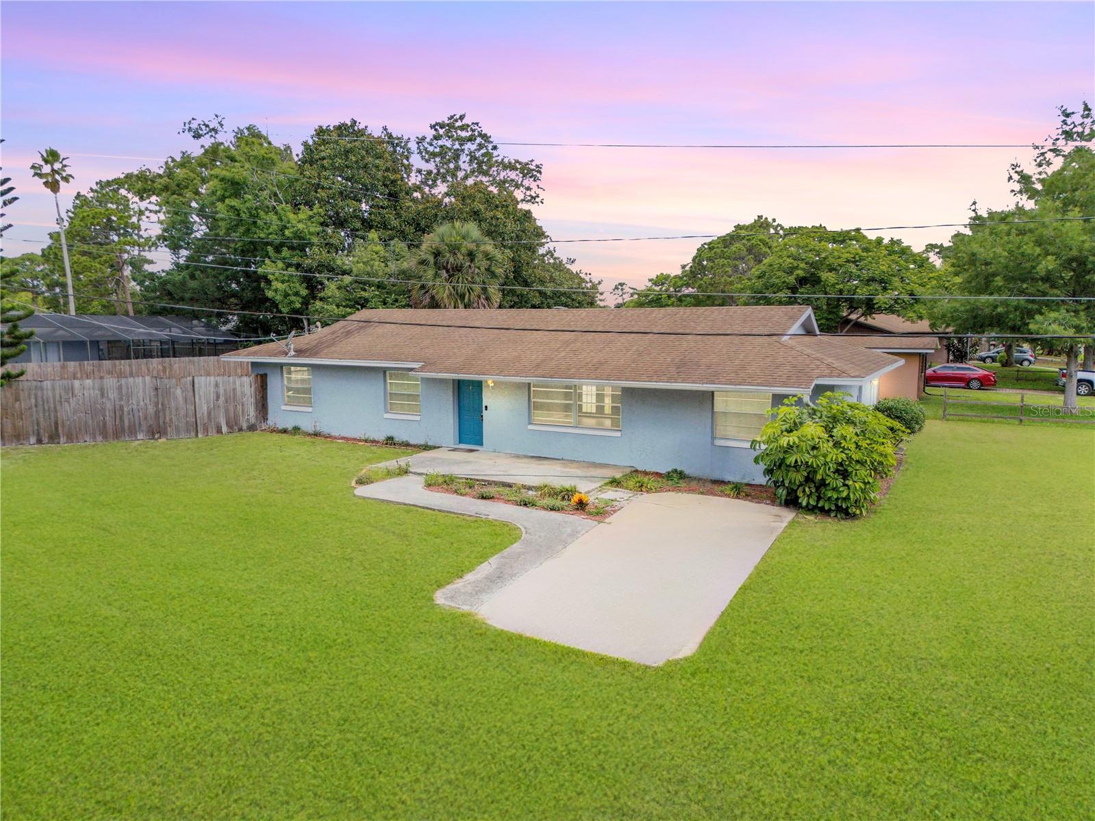 This beautifully maintained 4-bedroom, 2-bath concrete block home offers 1,534 square feet of comfortable living space, all situated on a massive corner lot with plenty of room to park your boat, RV, or toys. NO FLOODING — HIGH & DRY! Whether you're looking for a primary residence, snowbird retreat, or investment opportunity, this home checks all the boxes! Inside, you'll find a well-designed split floor plan, with a spacious primary suite and three additional bedrooms offering flexibility for guests, office space, or hobbies. The open-concept living and dining areas flow seamlessly into the kitchen, making entertaining a breeze. Step outside to enjoy the oversized yard—ideal for adding a pool, workshop, or simply enjoying the Florida sunshine in your own private space. Residents of Edgewater love the friendly, down-to-earth vibe and the strong sense of community that comes with living in this charming coastal town. From farmers markets and art festivals to car shows, local concerts, and holiday parades, there's always something fun happening to bring neighbors together. Plus, you're just minutes from riverfront parks, public boat ramps, the Intracoastal Waterway, and the beaches of New Smyrna Beach. Live where others vacation and enjoy the best of Florida's laid-back lifestyle—plenty of space, natural beauty, and a close-knit community, all just a short ride from the beach and river.