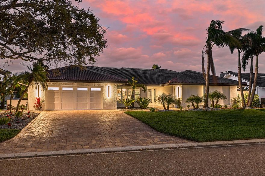 Tropical Waterfront Paradise in Bayway Isles – High and Dry! Experience luxury waterfront living in the exclusive, gated community of Bayway Isles in St. Petersburg, FL. This stunning four-bedroom, three-bathroom home with a den/studio is a masterpiece of design and craftsmanship, offering the perfect blend of elegance and coastal charm. Nestled on a deep through-water channel with direct access to the Gulf, featuring a new seawall, 16,000 lb boat lift, platform lift, and private dock, this residence is a boater’s dream. Best of all, this home is high and dry, never experiencing hurricane-related damage or flooding, providing peace of mind in a premier coastal setting. Designed with a thoughtful split floorplan, the luxurious owner's suite is privately tucked away on one end of the home, while a spacious ensuite guest retreat and two additional bedrooms are located on the opposite side—perfect for hosting family and friends. The additional den/studio offers flexibility as a home office, creative space, or reading nook. Every inch of this home has been meticulously updated with exceptional workmanship and attention to detail. The updated chef’s kitchen features top-of-the-line appliances, custom cabinetry, and luxurious finishes. New Spa-inspired bathrooms, elegant flooring, designer doors, and custom trim elevate the home’s sophisticated appeal. Fresh, modern paint throughout enhances the bright, open-concept design, seamlessly connecting indoor and outdoor living. Step outside to your private tropical oasis, where an expansive lanai and resort-style heated, saltwater pool with a new Pebble Tech finish create the ultimate retreat. Lush landscaping and beautifully designed hardscaping frame the outdoor space, offering tranquility and effortless entertaining. Ideally located just minutes from Fort De Soto Park, St. Pete Beach, the world-famous Don CeSar, and vibrant downtown St. Petersburg, this home places you at the heart of Florida’s best dining, shopping, and recreation. A rare opportunity to own a truly extraordinary waterfront home—schedule your private tour today and experience paradise! (The chandeliers in the dining room, breakfast area and rear hall do not convey.)