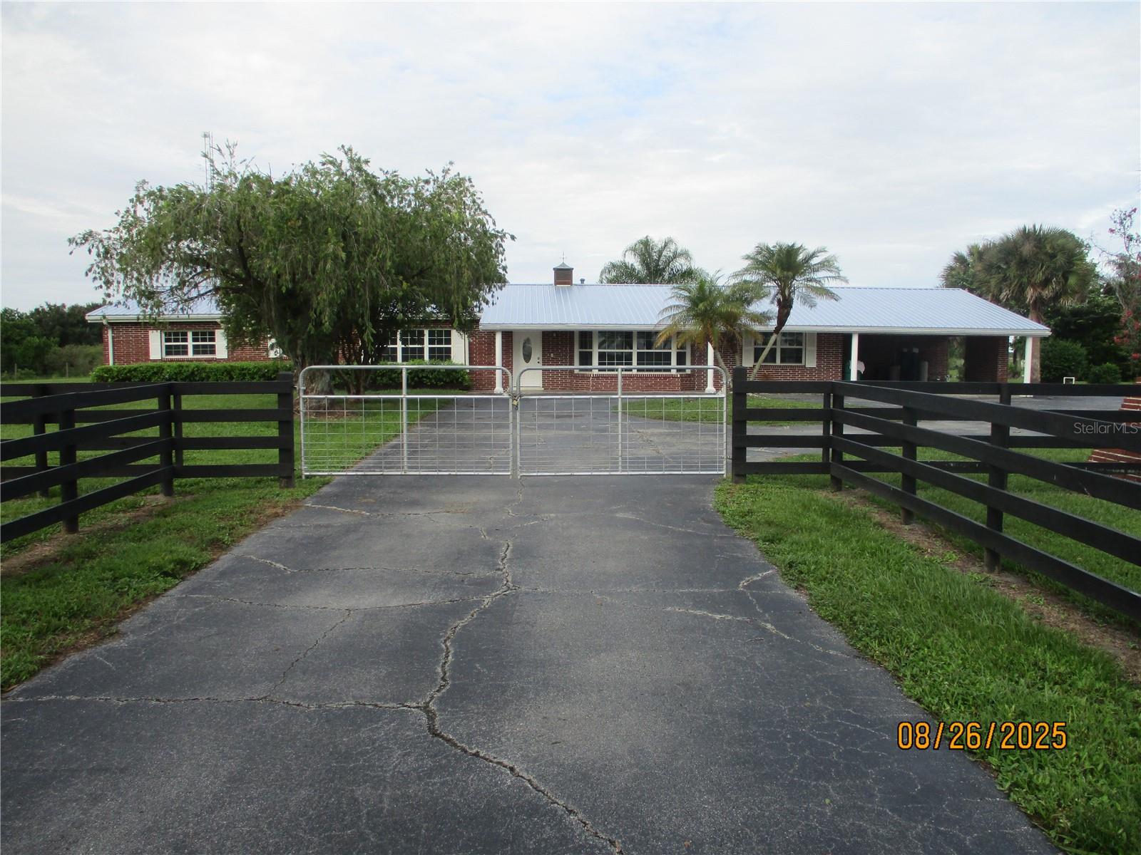 Charming Country Retreat on Nearly 5 Acres! Discover the perfect blend of comfort and countryside living with this beautifully renovated brick home, nestled on just under 5 acres of fully fenced land. Boasting four spacious bedrooms and four full bathrooms, this home offers ample space for family and guests alike. Recent upgrades include: A brand-new metal roof, Whole-house generator for peace of mind, New water heaters, New flooring, new countertops. An asphalt driveway with generous parking, including an attached double carport, Step outside and enjoy the serenity of your own private oasis. The property features: A full-sized pond ideal for fishing, Plenty of space for farm animals, An enclosed back porch leading directly to the sparkling pool. Whether you're looking for a peaceful escape or a functional mini-farm, this property has it all. Don’t miss your chance to own this slice of country paradise. Call for more information! All measurements are approximate, must measure for exact dimensions.