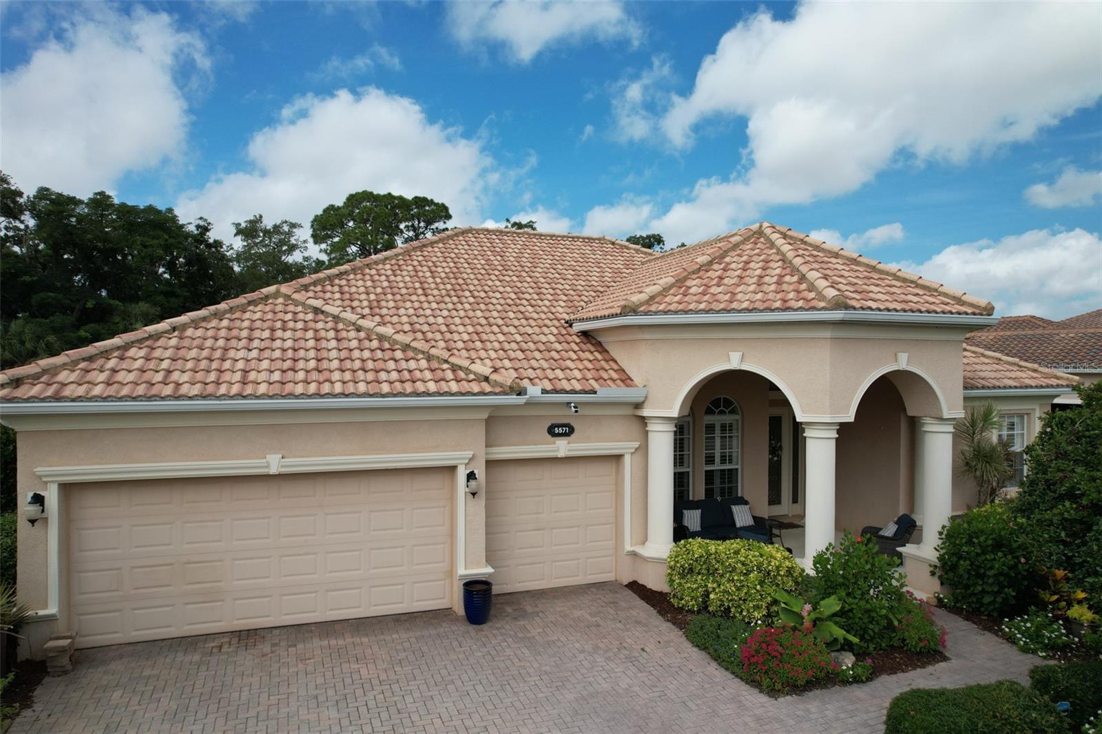 Welcome to this awesome Lennar home that will excite you when you enter with panoramic views of the private backyard with patio and pool area, through triple sliding glass doors. You’ll reside in the heralded Red Hawk Reserve, a premier, private, and gated community, perfectly located with shopping, a golf course, and the fantastic Twin Lakes Park nearby. The property is situated on a prime lot in the community with numerous lakes. This is a great neighborhood with sidewalks and is pet-friendly. You are welcomed to the front of the home by a spacious pillared covered porch. The front door is stained glass as are the side panels. Upon entry, you will be greeted by high crown molding ceilings and an open floor plan. In addition, the large, open kitchen is complete with solid wood cabinets, and tongue and groove drawers. There is also a large pantry. You’ll enjoy the granite two-tier bar countertops with plenty of bar top seating and a lovely kitchen and eating area with three-panel aquarium windows and relaxing pool and spa views. The grand owners’ suite is complete with a tray ceiling, four Bahama-shuttered windows, a large closet, an exterior door going out to your pool area as well as a resort-style bathroom with Bahama shutters, a spacious shower, a large tub, a separate sink counters and a private toilet area. The split plan provides for an additional three bedrooms on the opposite side of the home with two additional bathrooms, one being a pool bath and a potential en suite. The flooring is all commercial grade, with luxury wood vinyl plank throughout. The beautiful high-end pool is fully enclosed. It is self-cleaning with a Pebble-Tech finish, a pool heater, and a spa with a waterfall. The large deck with an alcove seating area also has a built-in pool bar with electricity for great entertaining and TV. The property abuts a preserve for privacy and the irrigation system draws from the lakes in the community. The backyard has an additional 26-foot concrete slab for an outdoor seating area, recreation or Tiki. It is truly an exceptional property with many amenities. The low HOA fee for this gated community home makes this an extremely sought-after property.