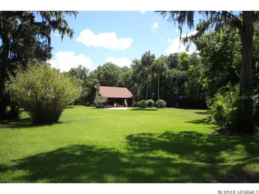 Need multiple use zoning? Ask for list of zoning uses. 6+ pristine, private acres on an Oak Hammock, high and dry. Real North Carolina Pine Log Home tucked in the forest of NSB. Need space for trucks, boats, business equipment- we got you covered with oversized 3 car concrete block garage with ground floor 1 bedroom garage apartment, PLUS carport with utility sink and covered "trench parking". Additional carport, shed and wood shed next to log home. No cookie cutter here- log home offers open floor plan with expansive covered porches front and back. Real wood burning stone fireplace in great room. 2 Large bedrooms downstairs. Master suite upstairs with 2 large walk in closets, office and lofted area overlooking the living room...great for a library,study or playroom. Feel secure in this solidly built log home with double pane windows, NEW ROOFS, termite bond & NO flood insurance required. Plenty of space to spread out - 3 acres under irrigation, next 3 your choice! Property backs up to 100+ acres of Utilities Commission land that will not be developed! 10 minute drive to pristine sandy beach. City of NSB maintains road. Have it All! Seller is ready to move. ;Water: City