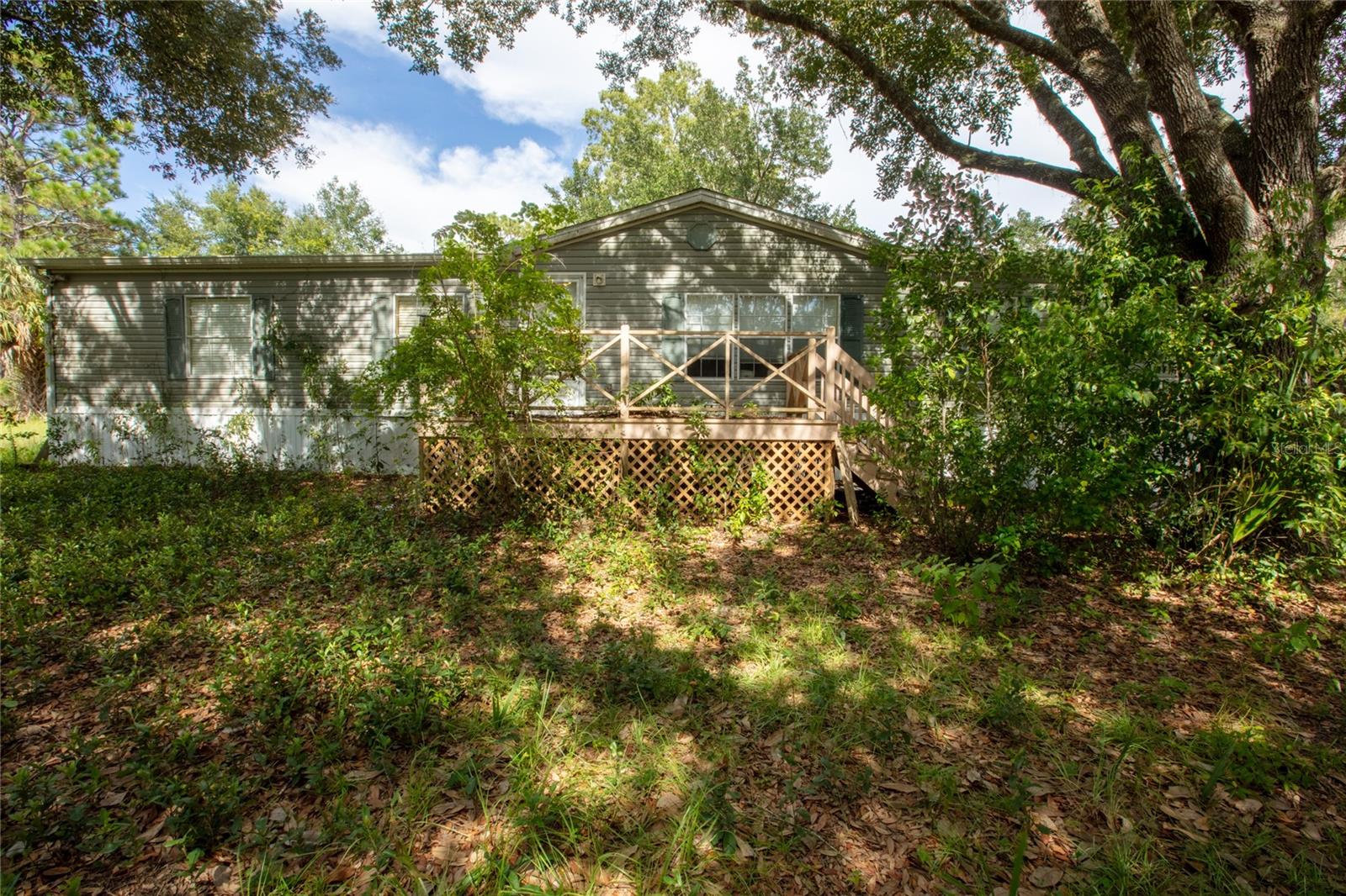 Spacious 3 BR/2 BA doublewide on peaceful 2 acres, offering 2,000 sq ft of living space, this home features a welcoming living room with built in shelving, and a convenient split bedroom plan. Outside, you'll find plenty of space to enjoy the great outdoors. Provides endless opportunities for gardening, recreation, or simply soaking in the natural beauty of the area maintained while the additional storage shed offers ample space for tools, equipment, or hobbies. Located in rural residential area of Melrose-Close to local amenities while maintaining a peaceful, country feel. Don't miss the chance to make this peaceful retreat your own and start creating wonderful memories. Easy commute to Gainesville, Jacksonville or Palatka. Needs TLC but lots of potential. Cash Only.