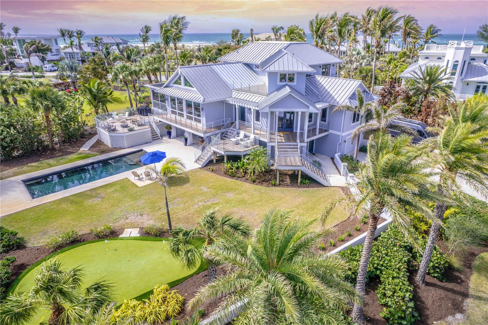 This Boca Grande beauty features a rare combination. It is both splendid for entertaining and well-planned for privacy, with a deck off every bedroom, a separate office or 4th bedroom and an elevator which reaches all floors. Outside, amidst tall palms and hibiscus flowers, challenge your guests on your own putting green. Toast the winner in the spa or the heated pool. Barbecue on one of the elevated IPE or Trek decks overlooking the pool, then warm by the gas fire pit just off the screened porch. Inside, you’ll enjoy formal dining, a granite kitchen with a convenient banquette, and soaring living room ceilings.
This home comes equipped with a Wolf gas range, Bose sound system, Miele, Bosch and Sub-Zero appliances, impact-resistant Anderson windows/doors and stunning Peruvian Mahogany floors. One story below is a versatile garage space with room for several vehicles, golf carts, jet skis, kayaks, paddle boards, bicycles or more. When not on the toys, family can spend time on the beach, nearby at multiple beach access points, including a deeded entry spot just around the corner. Here, you'll enjoy morning coffee to sunrises over the lake. In the evening, retire with sunsets over the Gulf from either suite's balcony. Boca Grande is a special life. Call for your confidential showing and take your place in it today.