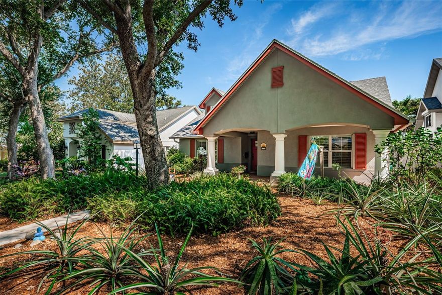 One or more photo(s) has been virtually staged. Welcome to this beautifully maintained 3-bedroom, 2-bathroom home offering 1,494 sq. ft. of comfortable, energy-efficient living, perfectly situated on a quiet, tree-lined street with a charming canopy overhead.

From the moment you arrive, you’ll be drawn to the inviting front porch—an ideal spot to enjoy your morning coffee or unwind in the evening. Inside, the home features vaulted ceilings and plantation shutters throughout, creating a bright, airy feel with timeless style. Fresh interior paint gives the entire home a crisp, move-in ready appeal.

The kitchen is well-appointed with granite countertops and stainless steel appliances, flowing seamlessly into the dining area and out through French doors to a stunning Florida room. This light-filled space also features double-pane hurricane impact windows and offers peaceful views of the backyard, your private oasis.

Step outside and discover a beautifully landscaped backyard that is a true gardener’s paradise, lush, well-maintained, and filled with vibrant flowers. Enjoy exceptional privacy and a serene setting that feels like your own personal retreat.

The primary suite is a retreat of its own, complete with a spacious walk-in closet with custom built-ins and an updated en-suite bathroom featuring dual sinks and a walk-in shower. Two additional bedrooms have been freshly painted and share a second bathroom with a tub/shower combination and single vanity.

Additional highlights include a dedicated laundry room with ample storage, a breezeway connecting the home to the two-car garage, and thoughtful upgrades throughout. Major systems have been updated, including a brand new roof, 2020 A/C, and a 2025 water heater. The exterior was freshly painted in 2023.

Energy efficiency is a standout feature with fully paid-off solar panels, keeping the average electric bill impressively low per month. Plus, the home is located outside of a flood zone for added peace of mind.

This home offers the perfect blend of comfort, efficiency, and charm—ready for its next owner to enjoy.