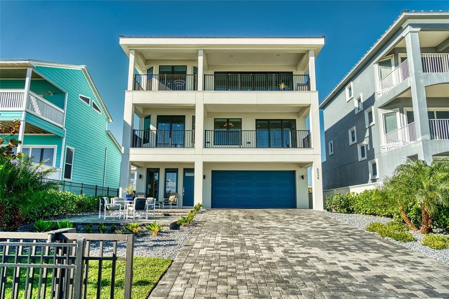 This 2021, 4 bed, 3.5 bath home plus office is waiting just for you. Dip your toes in the warm Florida sand & ocean surf just steps away from your front door. Located in the exclusive New Smyrna Beach Community of Bethune Beach; this portion of the beach is vehicle free. The gated & fenced front yard is perfect for oceanside entertaining with a large pavered seating area & covered lanai. Stepping inside, you’ll find the first-floor family room/media room with wet bar, wood look tile flooring & beamed ceiling. The first floor also hosts a bedroom with en-suite bath, 2-car garage, & access to the grassy backyard area. Take the stylish elevator or the solid wood stairs to the second floor where you’ll find the large primary suite with glass sliders leading to the full-length ocean facing balcony. This suite includes a huge walk-in custom closet, luxury carpet, morning coffee station with refrigerator, & stunning en-suite bathroom with dual vanities, separate toilet room, & a large tiled walk-in shower. Also located on the second floor are two more bedrooms (one also ocean facing), a shared full bath with dual sinks, & a laundry room. The third level comprises the main gathering spaces. Wood look tile flows as you step out of the elevator & find ocean facing wall-to-wall windows & glass sliding doors off the living room & formal dining room. Entertain family & friends around the giant quartz kitchen island with counter seating for up to 8. This kitchen has high-end appliances & tons of storage with pull-out drawers, a huge California Closet designed walk-in pantry, Five Star 6-burner gas-top stove with griddle, oversized stainless steel farmhouse sink, double Samsung wall ovens, & an under-counter ice-maker. Enjoy the ocean breeze & a cup of coffee while watching the Florida sunrise from your own private balcony off of the living room. The office with barn door & an half bath are also on this level. Custom window treatments & sound system have also been installed.