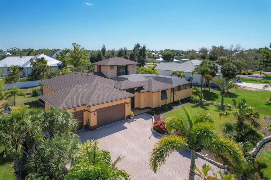 This Spanish and Italian inspired grand courtyard villa offers a blend of classic architecture, magnificent indoor and outdoor living space, and modern coastal construction quality. Priced to sell, the property is a tremendous value with 25,000 sq.ft. of land, nearly 2,800 sq.ft. of air conditioned space, nearly 2,000 sq.ft. of pool and lanai area, a 3 car garage, and room for a large outbuilding shed or additional garage. Gorgeous mahogany front doors open into the grand courtyard living area and pool lanai. Entertain, dine, or casually lounge in this stunning space with a large Spanish styled fountain offering serene water trickling sounds. The separate guest cabana suite offers unique privacy and opens directly onto the courtyard, and has its own full bath . The cabana is a favorite for guests and their hosts. The main home has another guest bedroom, den/office two full baths and the master suite upstairs has a charming balcony overlooking the courtyard pool area, and offers tremendous sunset views and partial views of the Intracoastal Waterway. The open layout combines the spacious kitchen, large great room and dining room creates into one sensational space with tall vaulted ceilings. The over half acre of land is beautifully landscaped with large mature tropical foliage, towering palm trees, and an enormous paver driveway that accommodates parking for multiple large vehicles. Engineered plans for a 22x24 outbuilding garage and much of the concrete block necessary to construct the garage are included in the purchase. The Association allows fencing, outbuildings, and room for vehicles. The Association has a private beach on Don Pedro Island, kayak launch and clubhouse. The picturesque Vanderbilt developed waterfront neighborhood brilliantly designed with over half acre lots winding around canals and the Intracoastal Waterway, and has grand banyan tree lined streets. The home is walking or golf cart distance to essential shopping, restaurants, and is close to historic Boca Grande, miles of tranquil beaches, three full service marinas, numerous golf courses, and world-class backwater and tarpon fishing.