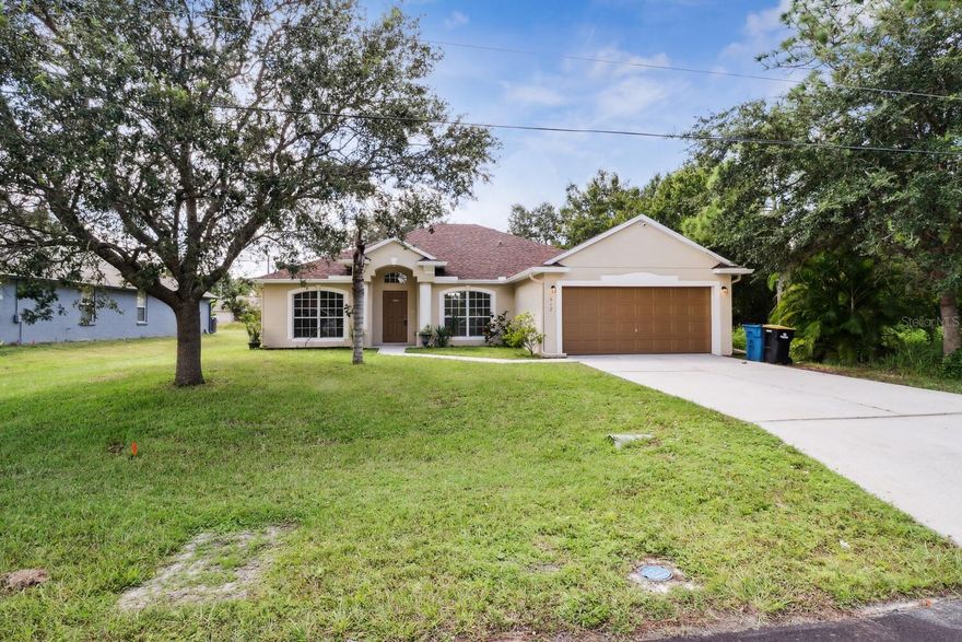 Welcome to 412 Ontario St NW in Palm Bay, where your new home awaits! This charming property boasts a private and serene lot, complete with no rear neighbors and ample backyard space for all your outdoor desires. As you approach, you'll notice the convenience of a two-car garage and a covered patio area, perfect for relaxation and outdoor gatherings. The thoughtful water retention system in the backyard ensures efficient drainage and peace of mind. Step inside to discover an inviting open floor plan that allows for versatile living arrangements. The front area features a spacious living/dining room combo, while the rear offers a comfortable family/kitchen room combo, providing endless possibilities for configuring your living spaces. The heart of the home is the open kitchen, boasting a convenient breakfast island that flows seamlessly into the family room. There's also a cozy eating space within the kitchen, making it an ideal spot for morning coffee or casual meals. Recent upgrades make this home truly turnkey. Fresh interior paint throughout and new flooring, featuring durable LVP in the living areas and plush carpeting in the bedrooms, create a modern and inviting atmosphere. When it comes to major systems, worry not. The roof was replaced in 2018, a brand-new HVAC system was installed in 2023, and a new water heater was added in 2021. Your peace of mind and comfort are top priorities. The kitchen is a chef's dream with brand new granite countertops, sleek stainless-steel appliances, and refinished cabinets, all contributing to a stylish and functional space. The master bedroom, located on one side of the house, provides a tranquil retreat. Additional bedrooms are situated on the opposite side, ensuring privacy and convenience. This move-in-ready home is eager to find its new owner. Don't miss this opportunity to make 412 Ontario St NW your own. Call today to schedule a showing and experience the charm of this lovely Palm Bay property for yourself.