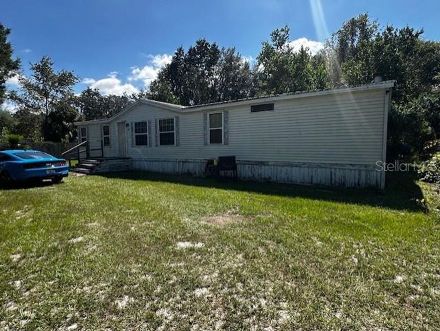 Discover the potential in this 3 bedroom, 2 bath manufactured home situated on nearly an acre in Lake Panasoffkee. The .96-acre property is fully enclosed with chain link fencing and includes a handy shed and carport for extra storage and convenience. Inside, the home offers a cozy fireplace and a spacious layout ready for your personal touch. While the home could use a little updating, the seller is open to making some improvements, giving buyers added flexibility. With plenty of space and great features, this property is a fantastic opportunity to create your own retreat.