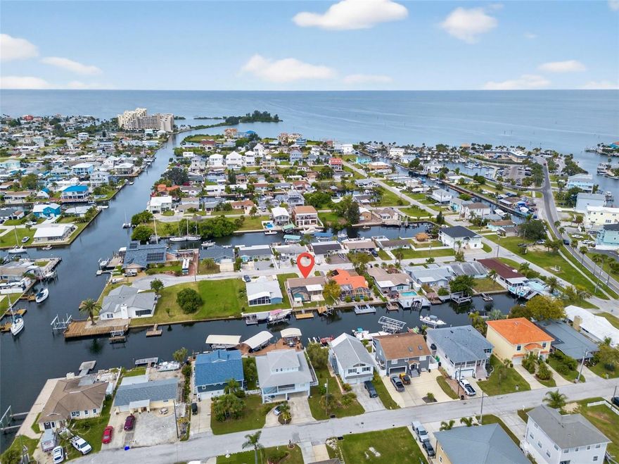 One or more photo(s) has been virtually staged. Your waterfront oasis awaits! Have you been dreaming of stepping out your back door and hopping onto your boat? No delays or bridges between you and open water?! Then this 3 bedroom, 2 bath, waterfront home is just what you've been looking for! Located on a quiet dead end street with deep water direct gulf access, this home gives all the vacation vibes! After a long day on the water soaking in rays and sport fishing, or sipping your morning coffee on the floating dock, go relax in your heated salt water pool with screened enclosure for low maintenance enjoyment. Includes private boat lift, plus davits and floating dock--room for the boat, jetski/skiff AND the kayaks. Meticulously remodeled from top to bottom, this home is LOW MAINTENANCE: block construction, new kitchen remodel, new floors, double paned windows with hurricane shutters, ample parking for 6 vehicles and a shed for all the toys. The list goes on. The bonus room (not included in the square footage) with portable AC makes an incredible flex space, bonus room, office or game room! Close to shopping, golf, beaches and Florida fun! Schedule your private tour today.