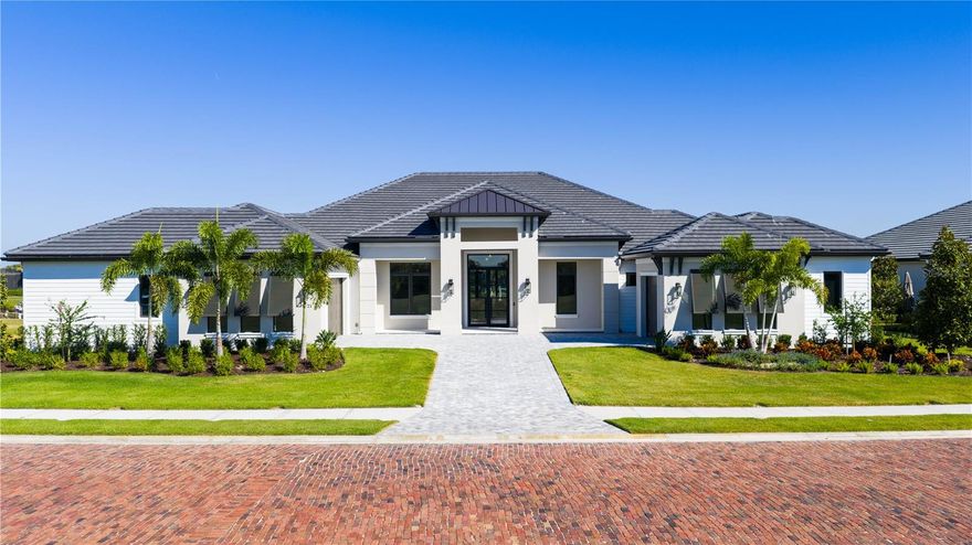 Offered for sale with an 18 to 24-month lease-back by builder, this brand-new stunning model home redefines luxury waterfront living. Featuring direct boating access to the Manatee River and Gulf of Mexico only three miles away, as well as a manned 24-hour access gate, this property is located in one of our area's most sought after communities.
Crafted by the award-winning team at Kemick Builders & Consultants—renowned for over 35 years of building custom showcase homes in Manatee and Sarasota counties, the Elliot Model is a striking example of transitional west-indies design, seamlessly blending timeless architectural charm with sleek modern sophistication. 
This fully integrated smart home offers over 4,300 square feet of thoughtfully designed living space across a single-story footprint. The Elliot model's open floor plan concept makes this home perfect for families, empty-nesters, or discerning individuals seeking single-level accessibility. The Elliot Model embodies clean lines harmonized with classic elements like warm wood accents, exterior trim siding, and soft neutral palettes.  
Premium features include the gourmet kitchen with quartzite waterfalls on an oversized island, custom cabinetry, and top-tier Thermador appliances. Dual dishwashers, a walk-in pantry, and ample prep space make hosting effortless. The luxurious owner’s suite features truly expansive walk-in closets, a morning bar, a cozy sitting area and direct lanai access. The primary bathroom offers dual vanities with lighted frameless mirrors, a freestanding soaking tub, a large dual-entry shower as well as a private outdoor shower. Two of the guest bedrooms surround a courtyard with fire-pit offering guests a beautiful and private setting to relax. A dedicated office/study with built-in cabinetry transitions smoothly into the casual family space of the kitchen, dining and great room, all connected by wide plank, white oak flooring. 
Speaking to Florida's indoor-outdoor lifestyle, the rear lanai spans over 800 square feet. A resort-style pool and spa overlook the water views, complemented by marble decking and a summer kitchen featuring a built-in grill, beverage center, and seating area with firepit. 
Nestled within the exclusive gates of The Islands on the Manatee River in Parrish, homeowners can enjoy access to amenities including River Lodge gathering facility, fitness center, outdoor sitting areas, and a dedicated community dock. Separate (optional) membership access to River Wilderness Golf & Country Club includes an 18-hole championship golf course, tennis and pickleball courts, Bocce ball courts, dining, banquet and clubhouse facility - all while being mere minutes from Sarasota's world-class beaches, cultural arts scene, and downtown Bradenton's vibrant dining. Parrish's rapid growth brings new shopping and amenities, yet this enclave preserves the peace of old Florida.