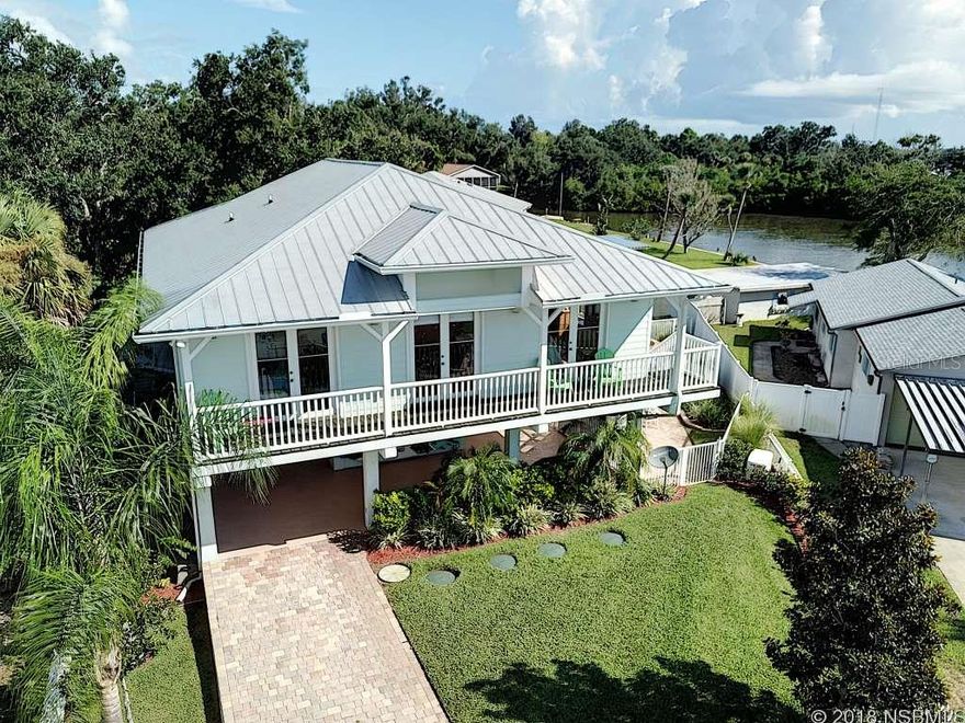 Old Florida Charm! Shows like a model. Canal-front Key West style home with 2/1 upstairs and 1/1 downstairs.  Perfect for a multi-generational family.  Private pool.  125 foot Bulkhead with Dock, electric boat hoist,(9,000 lbs),swim platform on canal with direct access to Intracoastal Waterway.  22 K generator with LP gas,(1+/- weeks backup).  Security system, Commercial Jacuzzi.New A/C  New insulation (R30).  Large shed with electric.  Well built, with stem wall and concrete second floor. Special sewage system.  Crown molding, New lighting system.  Sit on your second floor wrap-around porch, or on the lower deck, or on the river deck. This home is excellent for entertaining with decks galore. Home has a hot tub, (negotiable) Gas grill and amazing views from the second floor deck.   Paver driveway with extra parking leads to car port.  Fire pit next to the river.Home has a monitored alarm system and security coded locks. This is one of the most unique homes you will see, with an exceptional use of space, inside and out. Not in FEMA special flood plane. Painted in October new A/C. Edgewater water bill, located in County with Edgewater address.. ;Water: City