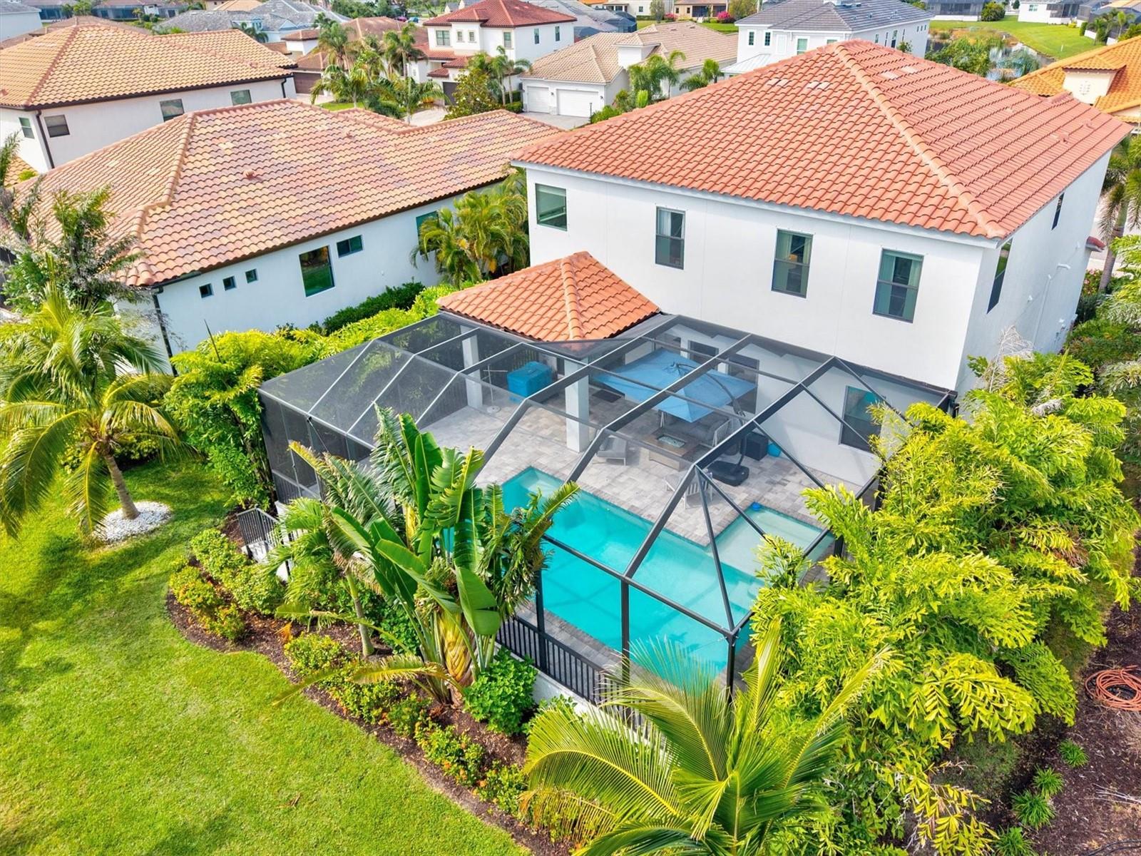 This seller is MOTIVATED! This incredible price invites you to make this home your own! Let’s make a deal! Introducing this breathtaking 4-bedroom, 3-bathroom pool home, nestled within the welcoming, most sought after gated community of Legends Bay, just moments from world-renowned IMG Academy and a short drive to St. Stephen's Episcopal School, Inspiration Academy and many other Bradenton educational options. This home is set amid lavish tropical landscaping... it is the epitome of Florida luxury design. This home is ideally located 10-20 minutes from the powdery sandy Gulf Beaches of Cortez, Coquina and Anna Maria Island, perfect places for relaxing and for your recreational activities including kayaking, paddle boarding, boating and more. This home is Florida luxury at its finest in an ideal location in Paradise. Â
Pride of home ownership shines throughout this home with newer paint, inside and out along with recently epoxied garage flooring.  Inside, you will find hard flooring throughout. Wood-look tile floors, high coffered ceilings, newer appliances, including washer and dryer, oven, refrigerator and microwave, giving you peace of mind. Additionally, newer upgraded interior lights with lifetime LEDs, California closets, a Gladiator organizing rack in the garage and a water treatment system are extra gifts that this home offers.  The open-concept great room flows into a chef’s kitchen with beautiful lighting from Restoration Hardware, a sprawling island, white shaker cabinets, stone countertops, glass tile backsplash, and stainless-steel appliances including a gas cooktop, providing the perfect space for family and friends to enjoy while studying, enjoying quiet time or entertaining. A butler’s pantry and very large walk-in pantry add extra convenience. The main floor includes a guest bedroom, full bath, and a front office/flex-room space. Upstairs, you'll find two more spacious guest bedrooms, a large bonus room, laundry room, and a primary suite with an extra sitting area, dual walk-in closets and a spa-like master bathroom featuring a soaking tub and walk-in shower. Â
In addition to the amazing interior, step through the sliders to your private screened oasis with a heated saltwater pool, sun shelf, paver patio and yard with room to play. This home offers an abundance of space and storage, giving you the perfect place for you to invite all of your friends and to enjoy easy living.  Residents of Legends Bay enjoy resort-style amenities including a clubhouse, pool, and fishing pier overlooking Sarasota Bay. With easy access to IMG, golf, tennis, pickleball, shopping, dining, and the beaches of Anna Maria Island, this home offers luxury, comfort, and an unbeatable location. Another draw to this location is the close proximity to Tamiami Trail and to Sarasota. This home and location offers an extremely appealing lifestyle, not only a house!  Come see, come sigh and make this home your own.