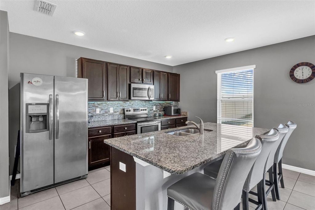 Photo of 269 Ludisia Loop, Davenport, FL 33837 (MLS # O6359603)