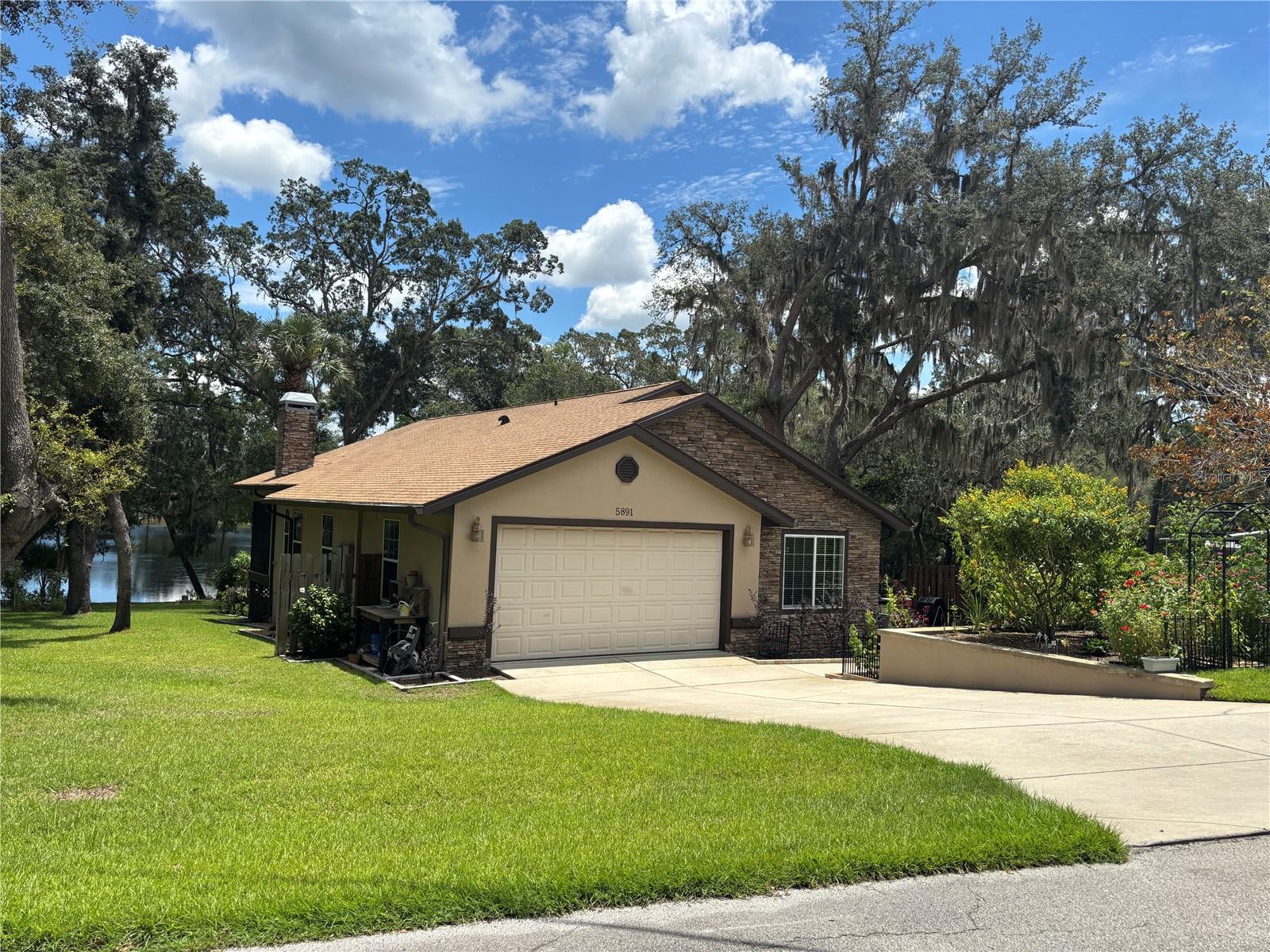 LAKEFRONT LIVING AT ITS FINEST! Enjoy the gorgeous Sunrise views from spring-fed Crystal Lake! Come see this elegant 3/2 Frame with stucco home on a spacious lakefront .55 acre on double lot! Home features a brand new roof in 2025 and new AC in 2018 that is serviced regularly. This property is a Gardner/Landscaper’s dream with a must see flower bed garden in the front of the home along with multiple flower beds and plant gardens throughout the property! Paved street neighborhood leading into a paved driveway with a 21 x 20 attached one car garage. Exterior beautiful stone siding on the front of the home, paved walkway with decorative rock garden around the home leading to a beautiful front entrance covered patio area with stone siding. 20 x 14 gorgeous side deck built around a tree that is a must see leading to a French door entrance. 20 x 16 back deck and a 20 x 9 screened porch that has a unique multi-panel three stage sliding glass door both overlooking Crystal Lake. You can also enjoy the lakefront views from the 21 x 12 open brick patio right at the water's edge along with brick seawall. Inside features a massive living room and a beautiful stone fireplace. Open kitchen with gorgeous granite countertops, along with a eat in kitchen bar, pretty stained-glass door pantry with pull out cabinets. Lots of natural bright light within the home, vaulted and high ceilings throughout with a dining area and inside laundry room. Guest bath has an elegant granite countertop vanity along with a tile shower. The master bedroom features a trey ceiling and has a large Bay window with a must-see lake view. Words can not do it justice! His and her walk-in closets lead into the master bathroom, which has his and her sinks with elegant granite countertops, Bathroom also features a Jacuzzi tub with a tile tub-surround/backsplash and a beautiful walk-in tile shower. This home has it all, make it yours today!