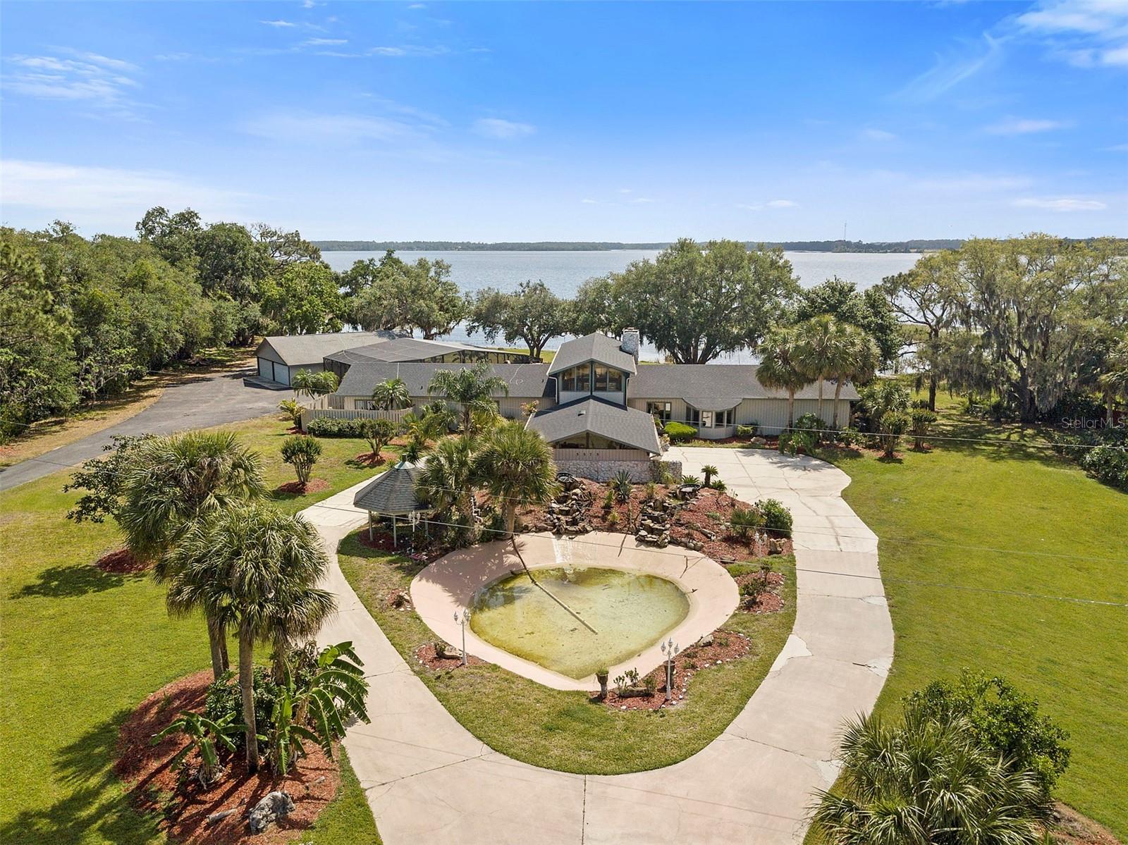 Bring your horses, cars, RV, boat, and jet skis! This outstanding waterfront custom property offers a private dock and 400' of frontage on Alligator Lake in desired Saint Cloud! The main house features 4 bdrms., 3.5 baths, and an attached 2 car garage. You will have plenty of room to roam on the main house plus hickory cabinets, travertine flooring, bonus room, and more. If you are a car enthusiast you will have plenty of room on the detached 6 car garage plus a 1 bdrm, 1 bath guest house with lakefront view as well. Entertain friends and family in the screened pool area with over 900 sq. ft. of space and summer kitchen. You will love the majestic oaks and extensive landscaping along with the soothing waterfalls and Koi Pond. Enjoy boating and water skiing on Alligator Lake, life is good!