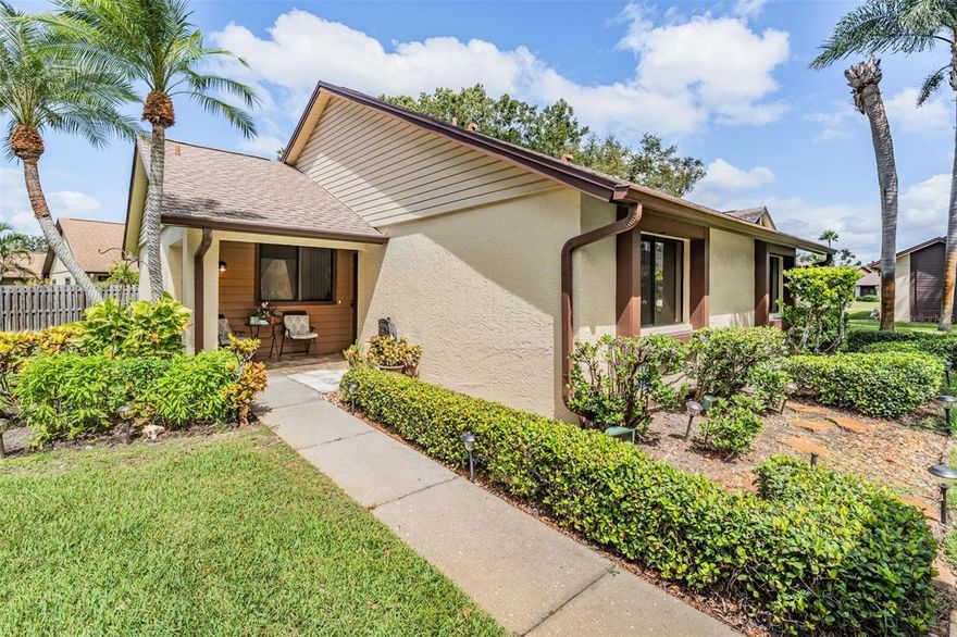 Rarely available! This meticulously maintained and elegantly updated 2 bed/2bath/1-car garage patio home is nestled within the desirable 55+ community of Village on the Green. Move in with peace of mind knowing you have a brand-new roof (2025), newer A/C (2023), and over $80,000 in upgrades including a full kitchen remodel, both bathrooms beautifully renovated, new flooring (no carpet), custom blinds, leaf gutters, fresh paint, and more. The open, airy floor plan is an entertainer’s delight. The modern kitchen shines with granite countertops, stainless steel appliances, a tile backsplash, and abundant cabinetry and counter space. It flows seamlessly into the dining and cozy living areas, creating the perfect gathering space. A bonus Florida room invites you to enjoy morning coffee or evening relaxation, and the outdoor patio offers a peaceful place to unwind while admiring the lush greenery and gentle sounds of nature. The spacious primary suite features ample closet space and a luxurious granite vanity with a seated makeup area. The primary bath includes a step-in shower, while the guest bath offers a relaxing tub. The low HOA fee covers lawn maintenance, basic cable, and access to an array of amenities — including a sparkling lakefront pool, fitness center, library, shuffleboard courts, and an active clubhouse with yoga, cards, crafts, and social gatherings. No CDD fees. Located just minutes from downtown Dunedin, Honeymoon Island, Caladesi, and Clearwater Beach, plus local shops, restaurants, and weekend artisan markets — this home offers the perfect balance of peaceful living and vibrant convenience.  Schedule your private showing today and make it yours!