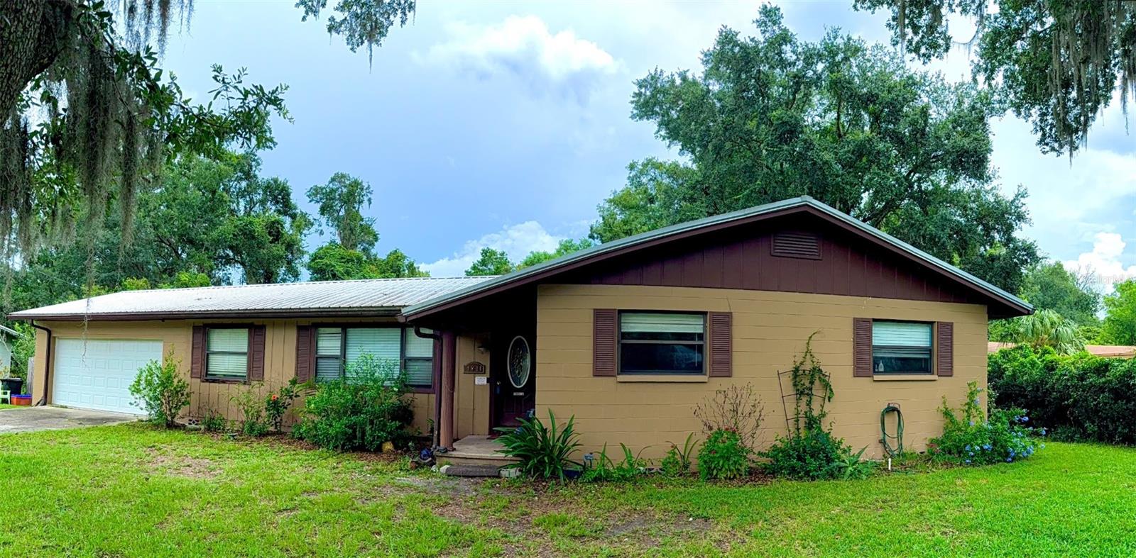 Tucked away in the charming neighborhood of Northwood, this remarkable home stands as the largest in the area, boasting an impressive 2,334 heated square feet on a serene 0.51-acre lot along Possum Creek. Designed with a thoughtful split floor plan, the layout ensures a perfect blend of privacy and comfort. The expansive living area features a cozy wood-burning fireplace, flowing seamlessly into a large open kitchen with clean, practical tiling, stainless steel appliances, a picturesque backyard view with convenient access to a two-car garage, offering ample storage space along with a dedicated laundry area. A true retreat, the master suite offers a wealth of space and comfort. Significant updates include modernized guest bathrooms and plumbing (upstairs and downstairs), stylish new flooring in two bedrooms, and a HVAC system (2021). Venture downstairs to discover a finished mother-in-law suite - this versatile space doubles as an Air B&B, man cave, or hobby room, complete with a private entrance.
Enjoy your morning coffee or evening cookout in the privacy of your fenced-in backyard with a spacious deck. Surrounded by Florida's natural beauty, you'll immerse yourself in the sound of bird songs, while marveling at wildlife passing through and enjoying the lovely creek just beyond the woods. Ideally located just minutes from I-75, this residence provides quick access to UF, Santa Fe, Shands, and North Florida hospitals, along with an array of nearby shopping, dining, parks, and schools, all while preserving the tranquil charm of suburban living (without the restrictions of a HOA!).