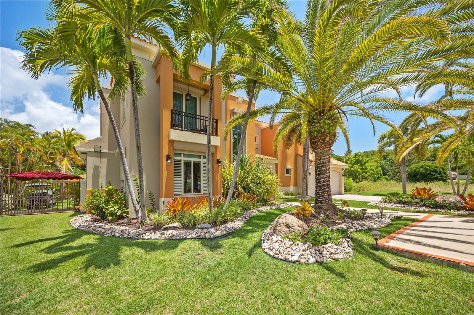 Discover this stunning two-level estate nestled within the gated community of Harbour Light Estates, located in Palmas del Mar resort on Puerto Rico's beautiful east coast. Situated at the end of a quiet cul-de-sac, this contemporary home offers elegance, comfort, and convenience.
Boasting over 3,000 sq. ft. of living space, this home features:
•5 spacious bedrooms (including one on the ground floor, perfect for a home office or guest room
•3.5 bathrooms
•Two-car garage with additional driveway parking
•Storm shutters
•Private pool and jacuzzi
•Gazebo
•Generator
•Expansive 1,550 sq. m. lot
•Annual property taxes: $4,000 Approx
Step outside to enjoy a spacious outdoor terrace surrounded by lush landscaping ideal for hosting family and friends. This tranquil oasis offers the perfect escape, while still being just moments from Palmas del Mar’s luxury amenities.
This home is your gateway to life in one of Puerto Rico's most desirable resort communities.
This property is being offered unfurnished.
Listing Price: $1.8M