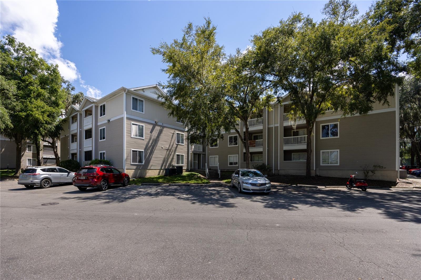 Owner is open to assume the VA loan at a low interest rate of 3.125%! Welcome to this remodeled and furnished 4 bed 4 bath condo in Countryside. Great location close to the University of Florida, Shands Hospital, Celebration Pointe, and shopping. Enjoy a furnished and spacious living room with new vinyl flooring (2025). Updates include fully repainted (2022), new fans (2022), new Samsung washer and dryer (2022), new dishwasher (2025), and new living room vinyl flooring (2025). Off of the living room there is a covered porch with a storage closet. Each bedroom has a walk-in closet, its own bathroom, and is furnished with a frame and mattress. Community amenities include a pool, fitness center, basketball court, and volleyball court. The Internet is also included in the monthly association fee. This unit would make a great investment property or to rent out while your son or daughter goes to UF or Santa Fe. Located near the bus routes to UF.