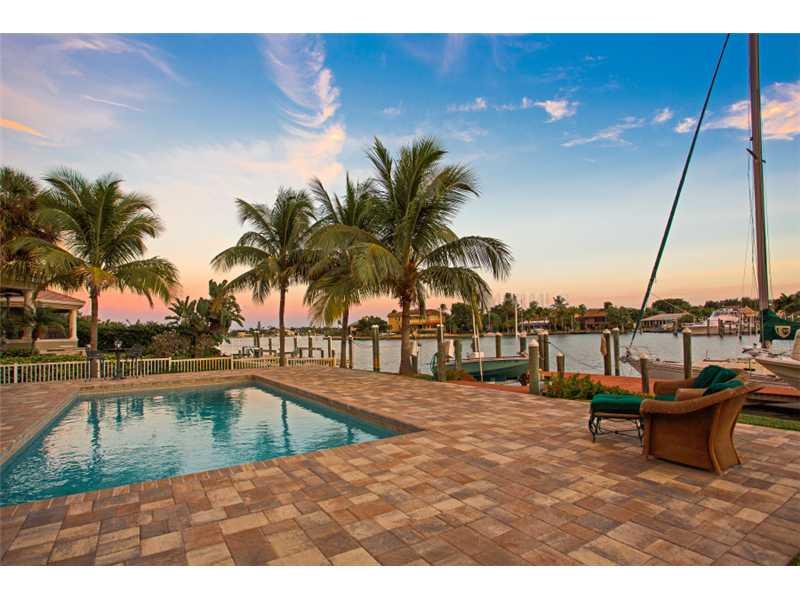 Wake up to peaceful views of Roberts Bay from this graceful waterfront home, privately set on the north end of Siesta Key. Exuding understated island elegance, this home affords one of the finest sailboat basins in Sarasota, with an impressive 60 ft. dock, two lifts and sailboat slip. The main residence offers three bedrooms and over 3,200 sq. ft. of living area, with a contemporary feel that softly blends with the authentic character of tongue and groove ceilings, a wood burning stone fireplace and bamboo flooring. A private guest house accommodates friends and extended family comfortably, with a spacious living area, cozy kitchenette and en-suite bedroom. The Bayfront patio is complete with paver decking and a private open pool, inviting you to refresh and re-energize, before enjoying relaxed al-fresco entertaining. Just minutes from world-famous Siesta Key Beach and the eclectic charm of Siesta Village, this home offers a life of casual island sophistication, with the refined pleasures of nearby Sarasota at your doorstep.