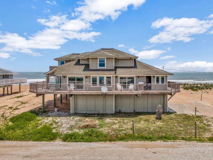 Welcome to a once-in-a-lifetime opportunity to own a truly exceptional seaside home in the highly coveted and private Summer Haven community. Nestled along a quiet, private road with no public beach access, this direct oceanfront estate also boasts rare river frontage—offering breathtaking panoramic views of both the Atlantic Ocean and the Summer Haven River. Designed to maximize its stunning surroundings, this 4-bedroom, 3-bathroom coastal retreat features a wrap-around porch where you can savor both sunrises over the ocean and sunsets over the river. Every room in the home offers a view, filling the space with natural light and the soothing ambiance of coastal living. The open-concept kitchen is a chef’s dream, showcasing elegant granite countertops, top-of-the-line appliances—including a Viking refrigerator—and plenty of space for entertaining. Their are 2 owner’s suites with unparalleled ocean views, spa-inspired bathrooms with dual vanities, large walk-in showers, and spacious walk-in closets. Additional highlights include a 3-car garage with storage space, spacious guest bedrooms with ocean or river views, and seamless indoor-outdoor living spaces that embrace the unique beauty of this rare location. This is more than just a home—it's a lifestyle of privacy, luxury, and unmatched natural beauty. Opportunities like this in Summer Haven are incredibly rare. This property would also make for a great Short Term Vacation Rental! Don’t miss your chance to own one of the most unique properties on Florida’s coast.