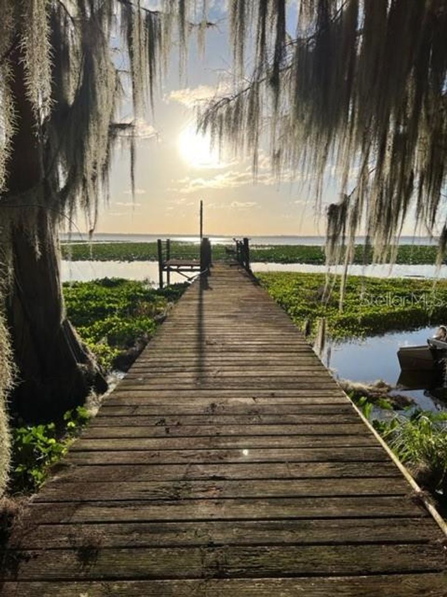 HANDYMAN SPECIAL WITH A MILLION-DOLLAR VIEW!!  Double-wide mobile home on stunning lot overlooking Lake Lochloosa.  Dock adds a perfect sitting location to watch amazing sunsets! Walking distance to Lochloosa Harbor Fish Camp and public park with boat ramp.  Lake Lochloosa covers 5700 acres and is located along Highway 301 about 5 miles south of Hawthorne, close to Lochloosa town. The lake’s shoreline is bordered by aquatic plants such as spatterdock (bonnets), knotgrass, and old-growth cypress trees. Lochloosa Lake along with various other water bodies within the basin is recognized for its economic and ecological significance. It has a long-standing reputation among anglers for its sport fishing.  More information on Lake Lochloosa:  https://bassonline.com/fl/lakes/lochloosa-lake/