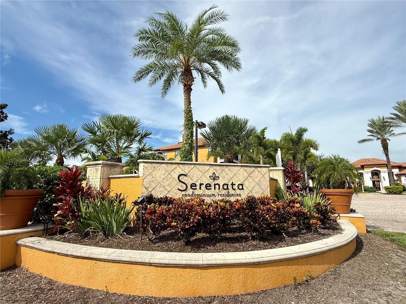 Rarely available first-floor condominium in the highly sought-after gated community of Serenata, where resort-style living meets convenience! This spacious home welcomes you with an open-concept floor plan and features two en-suite bedrooms, each with a walk-in closet for ample storage. Enjoy the screened lanai with a storage closet, seamlessly extending your living space, while the built-in shelves add both style and functionality. The kitchen is equipped with a breakfast bar, solid wood cabinets, and flows perfectly into the main living area. An in-unit laundry room with washer and dryer completes the package. Serenata offers unmatched amenities: a heated saltwater pool, lighted tennis courts, 24-hour fitness center, clubhouse with game room, billiards, library, and even a convenient car wash station. Stroll along the lakeside walking path, relax at picnic tables, or enjoy outdoor grilling surrounded by lush, manicured landscaping. Located in the heart of Sarasota, just minutes to UTC Mall, SRQ Airport, St. Armands Circle, medical facilities, fine dining, and the world-famous gulf beaches. Experience the perfect blend of luxury, location and life style in this maintenance free community.