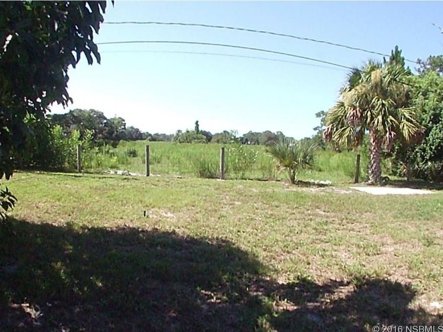 Two bedroom, two bath home backing up to a open field area that is undeveloped and gives privacy.  Laminate wood floors throughout the home.  New roof on home in May 2016.  Screened porch to enjoy the breezes.  Beautiful wood burning fireplace. ;Water: City